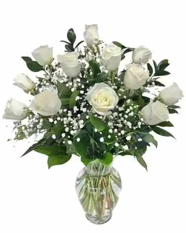 White Dozen Roses - Timeless, elegant, and endlessly romantic, our Classic White Dozen Roses is the ultimate expression of love and admiration. This stunning arrangement features 12 premium long-stem white roses, beautifully accented with fresh baby’s breath and lush greenery, hand-arranged in a clear glass vase for a clean and sophisticated finish.  Each rose is carefully selected for its rich color, velvety petals, and long-lasting beauty, making this bouquet a perfect choice for anniversaries, birthdays, Valentine’s Day, romantic surprises, or simply to say “I love you.”  At Gallery Flower Shop N Services, we pride ourselves on delivering timeless floral designs with exceptional quality and service. This classic dozen roses arrangement never goes out of style and always makes a powerful statement.
