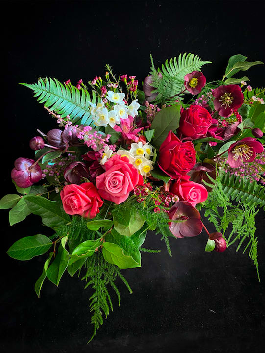 Woodland Valentine - Fern, Hellebore, Heirloom Roses and Narcissus blooms come together to present a beautifully seductive woodland bouquet. This design measures approximately 22" x 14" in our signature horizontal style.   While we can promise amazingly beautiful, seasonally fresh and locally grown flowers in your gift, we can not promise exactly what they will be. Photos shown depict the look and feel of each design. We send a photo of the actual flowers sent out, so you can see what unique beauty you have brought to your loved one.   **A note on the element of “Surprise” We’ve discovered it is imperative we make delivery arrangements with the recipient prior to delivery. Experience has shown that dogs, locked gates, no safe place to leave flowers, people on vacation, overly hot days- they happen! Our top priority is getting your perishable gift safely into the hands of your lucky recipient. We have found even with advance notice, the person receiving beautiful flowers is surprised and delighted upon seeing them for the first time.  We typically deliver between 1-5pm. If you need a specific delivery time, you may select delivery time at check out for an additional fee. We do not offer timed delivery on busy holidays. All of our deliveries follow COVID safety guidelines.  -Thank you, California Sister  