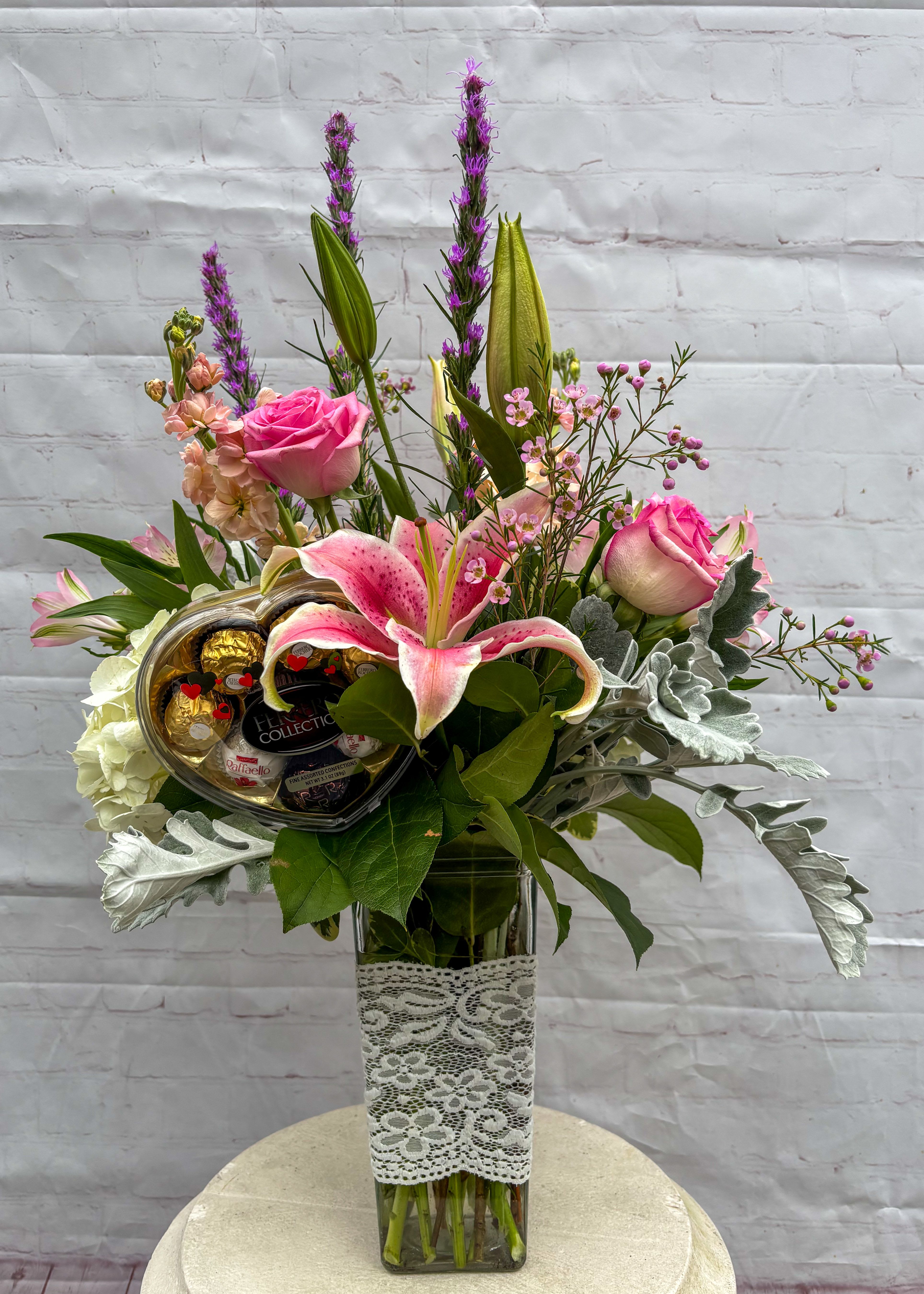 Sweet Valentine - This sweet Valentine's Arrangement speaks to the heart. Arrangement includes a box of 7 pieces of Chocolate. Red Roses, Hydrangea, Lily, Tulips &amp; Cremone Mums.