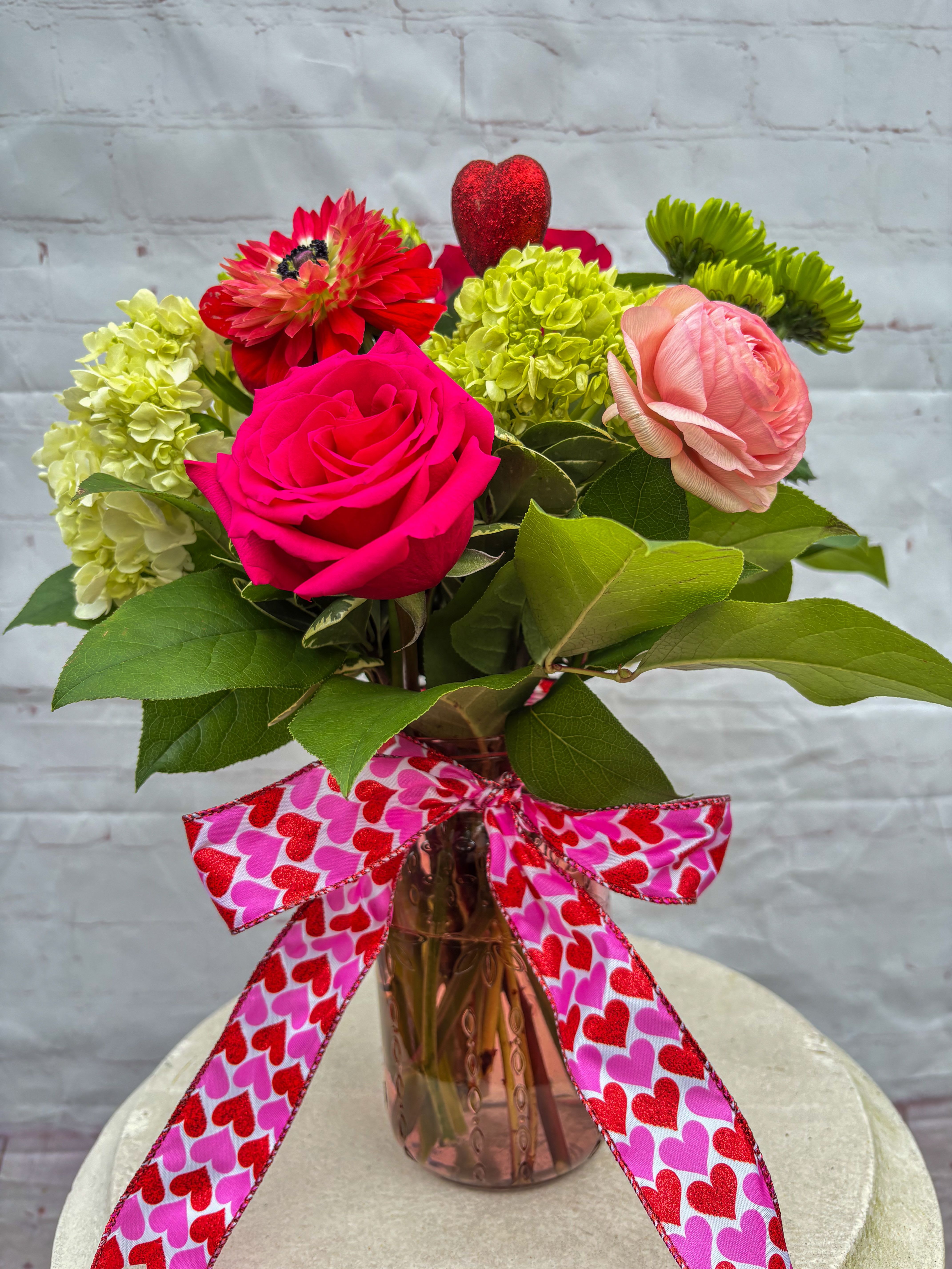 The Cupid - Charming Arrangement with green Hydrangea, green Spider Mums, Roses, Orchids, Anemones and Tulips. Colors will vary slightly depending on availability.