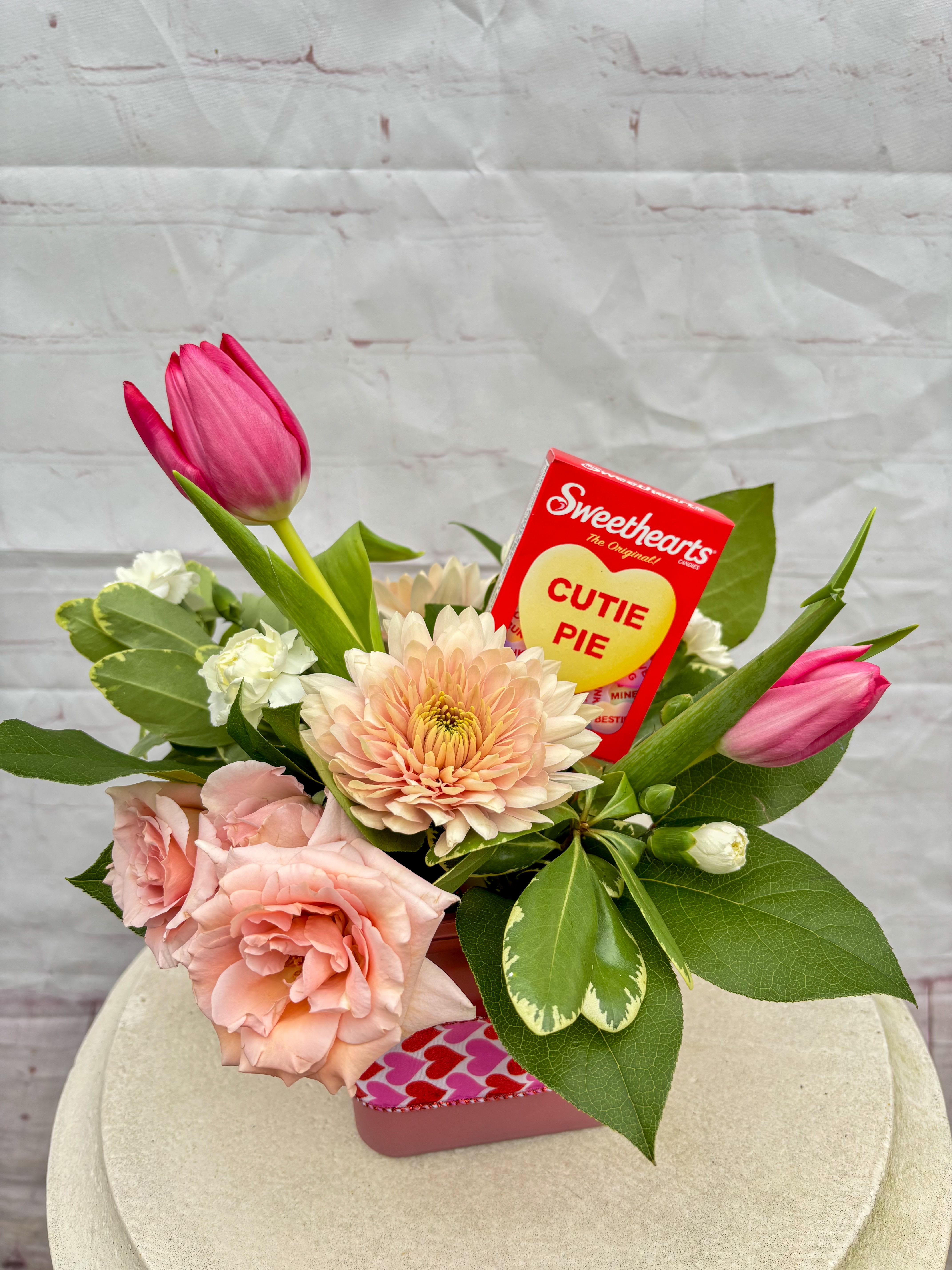 Cutie Pie - The Cutie Pie Arrangement combines soft spray roses, fresh tulips, and complementary blooms with a sweet touch of Sweethearts candy.