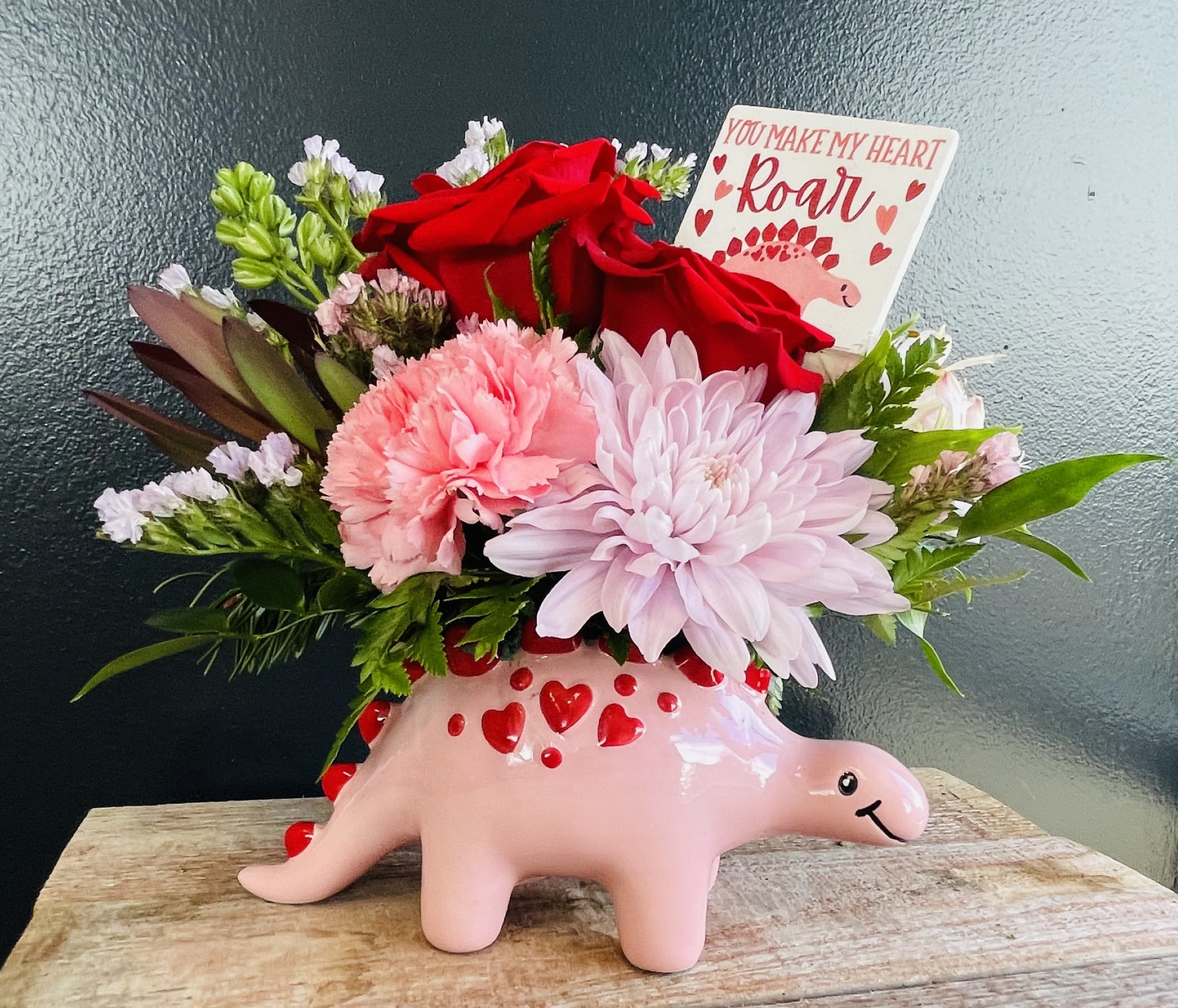 Dino-Mite  - Introducing the Dino-mite bouquet, where prehistoric meets pretty! This adorable arrangement features fresh flowers expertly crafted into a Valentines edition dinosaur container. 