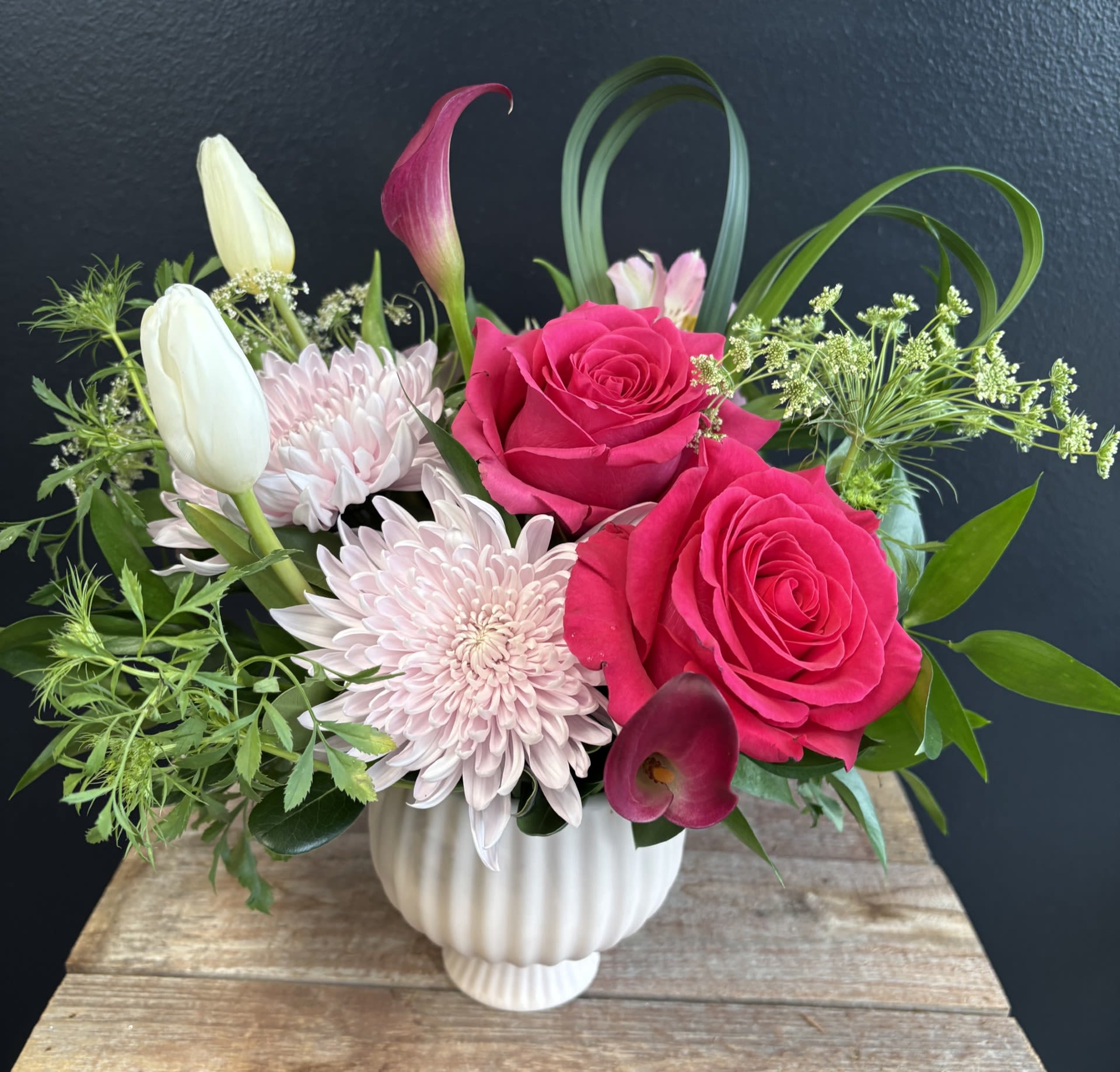 Dreamlover  - A soft pink compote bowl cradles a dreamy collection of blooms, creating an arrangement that feels tender and effortlessly romantic. Pinks may vary in color.