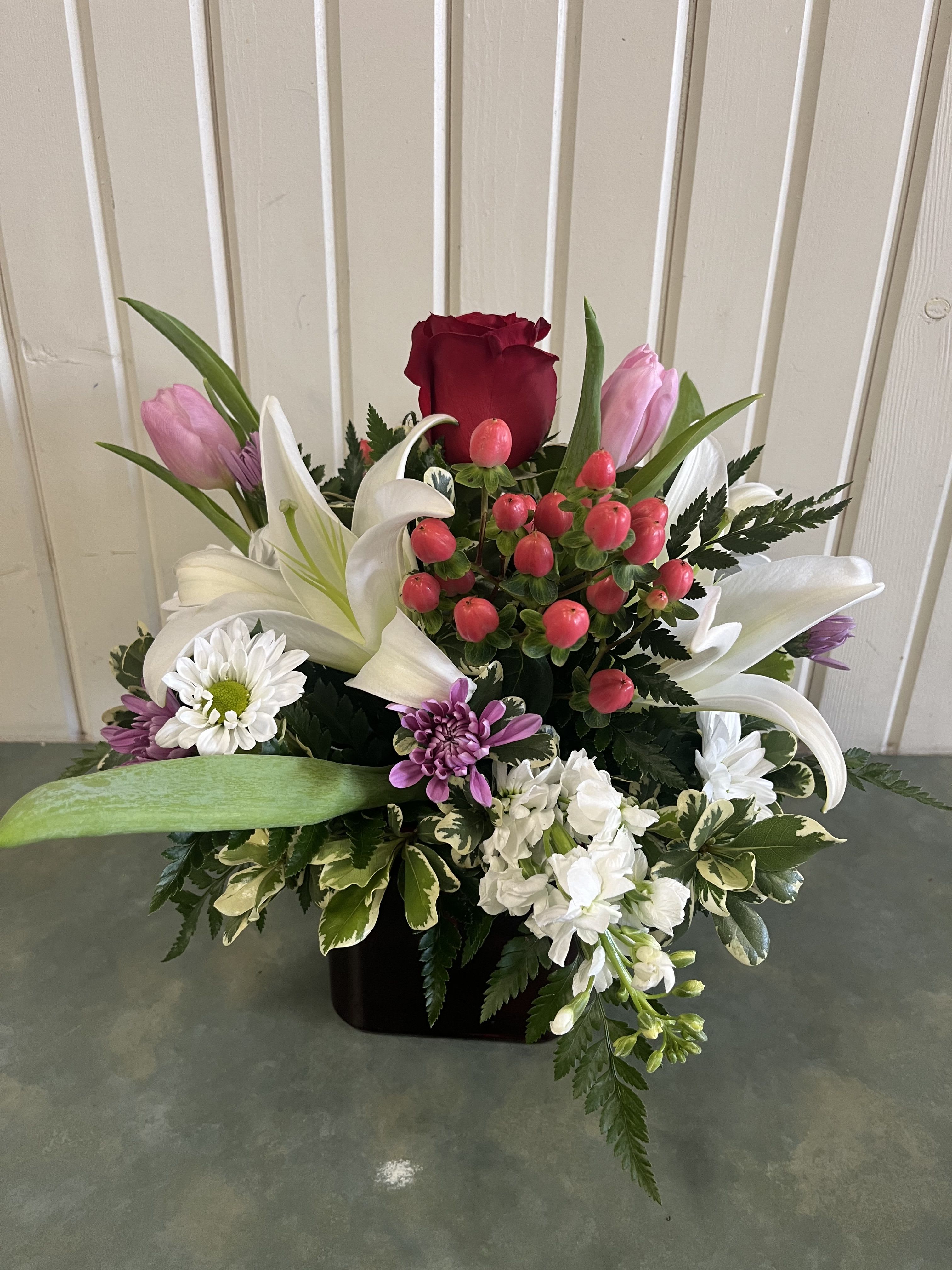 Keys to My Heart Bouquet - Red glass cube with roses, lilies, daisies, stock &amp; tulips in reds, pinks &amp; lavender  All around arrangement  Approximately 14” tall