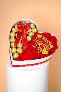 Sweetheart - A lavish heart-shaped box featuring premium red roses paired with decadent Ferrero Rocher chocolates, finished with Bloom Luxury Box’s signature ribbon and romantic Valentine accents. Sweetheart Indulgence Luxe is the perfect balance of passion, sweetness, and luxury.