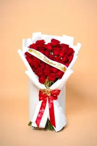 Valentine's Embrace - This stunning bouquet features radiant red roses arranged to create a bold and romantic statement. Finished with a signature ribbon and elegant wrapping, Valentine’s Embrace delivers love in its purest and most sophisticated form.