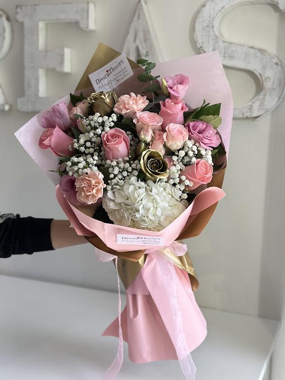 Rose Gold - Handheld arrangement, white, pink and gold colored flowers.  Arrangement does not include vase, if you'd like one please call to request. 