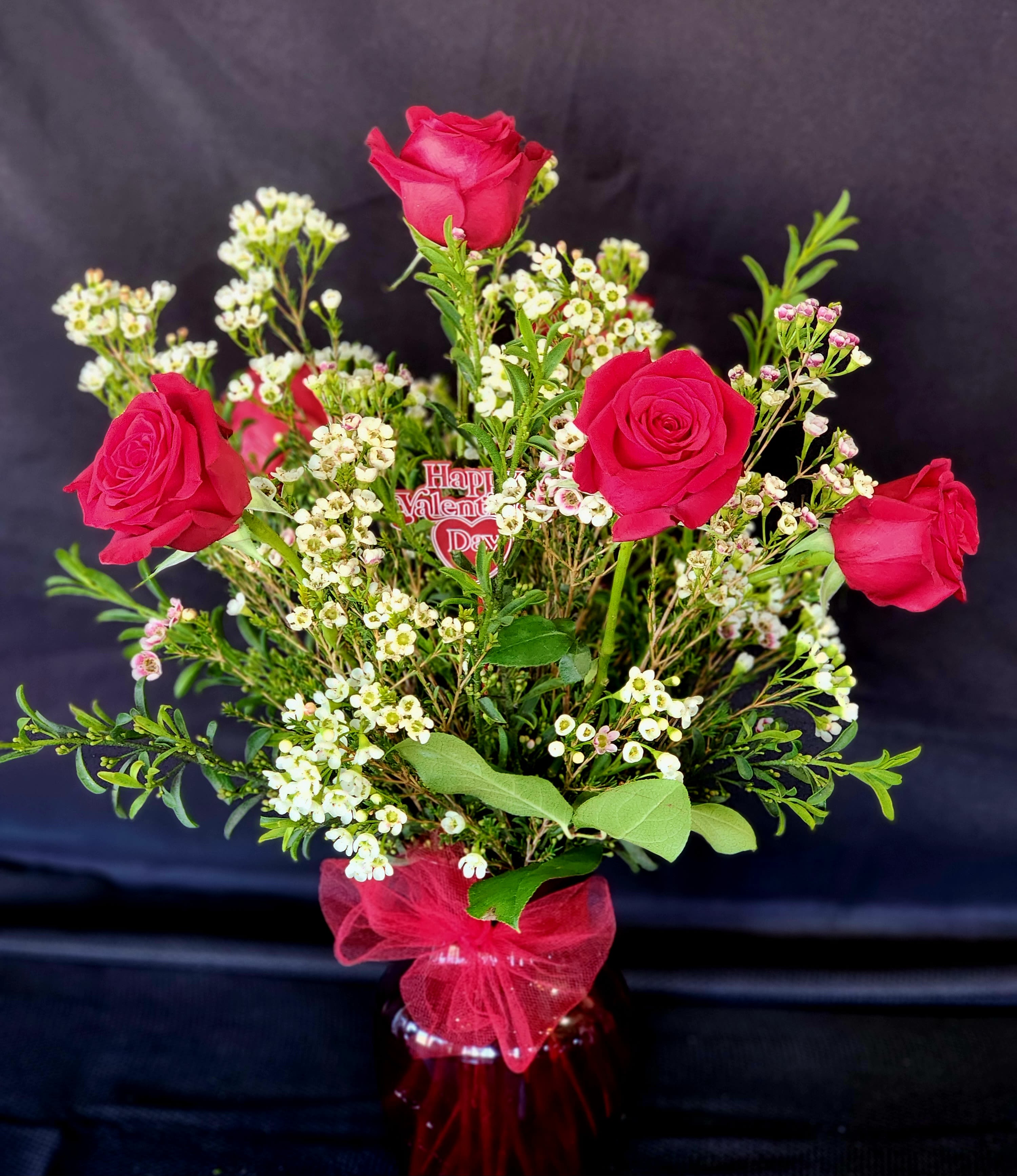 Half a Dozen Roses ***ONLY AVAILABLE FOR THE WEEK OF VALENTINE'S*** - 6 roses with Eriostemon foliage and Wax flowers-citrusy and fruity tones that compliments roses. In an 8" vase and approximately 20" high.