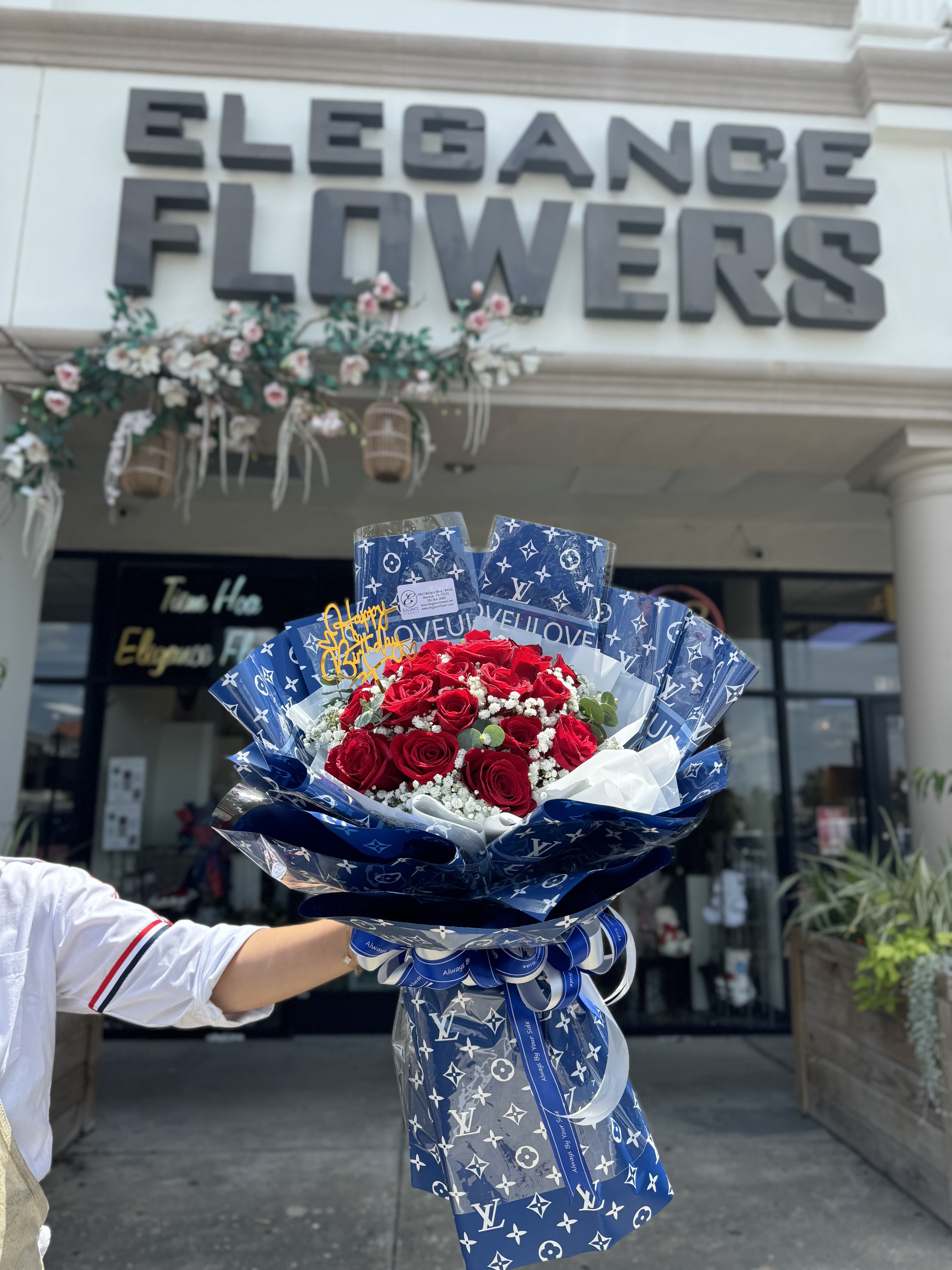 Wrapped Bouquet #12 - A wrapped bouquet of flowers is a beautifully arranged collection of blooms, carefully selected and elegantly wrapped in decorative paper or fabric. These bouquets often feature a mix of fresh, vibrant flowers, and complemented by lush greenery. Wrapped bouquets are perfect for any occasion, from expressing love and gratitude to celebrating special moments, offering a thoughtful and visually stunning gift.