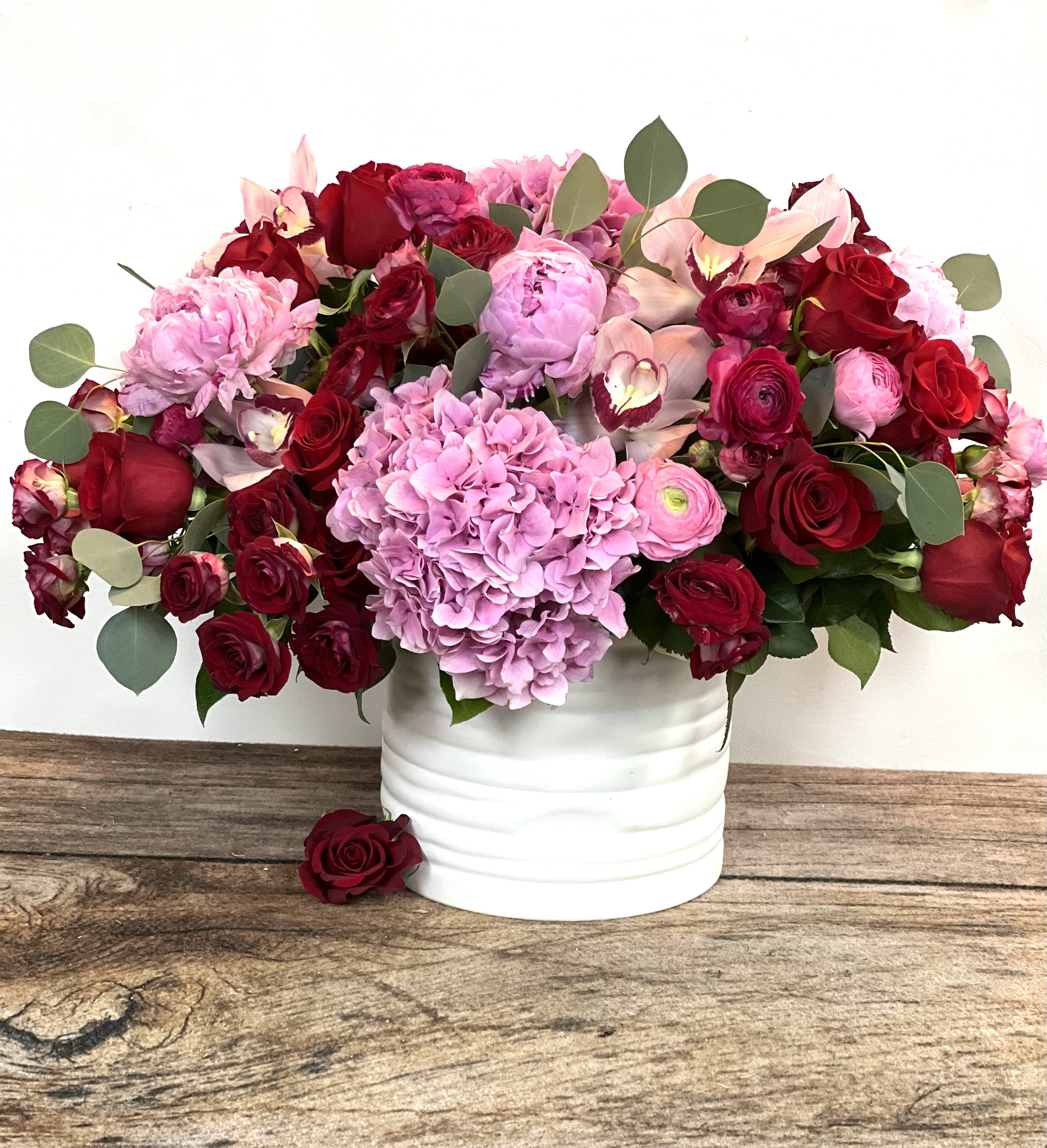 Infatuated - Our grandest, most romantic display of love! A blend of pink and red premium blooms packed into a ceramic container. Approx. 16"h x 20"w.