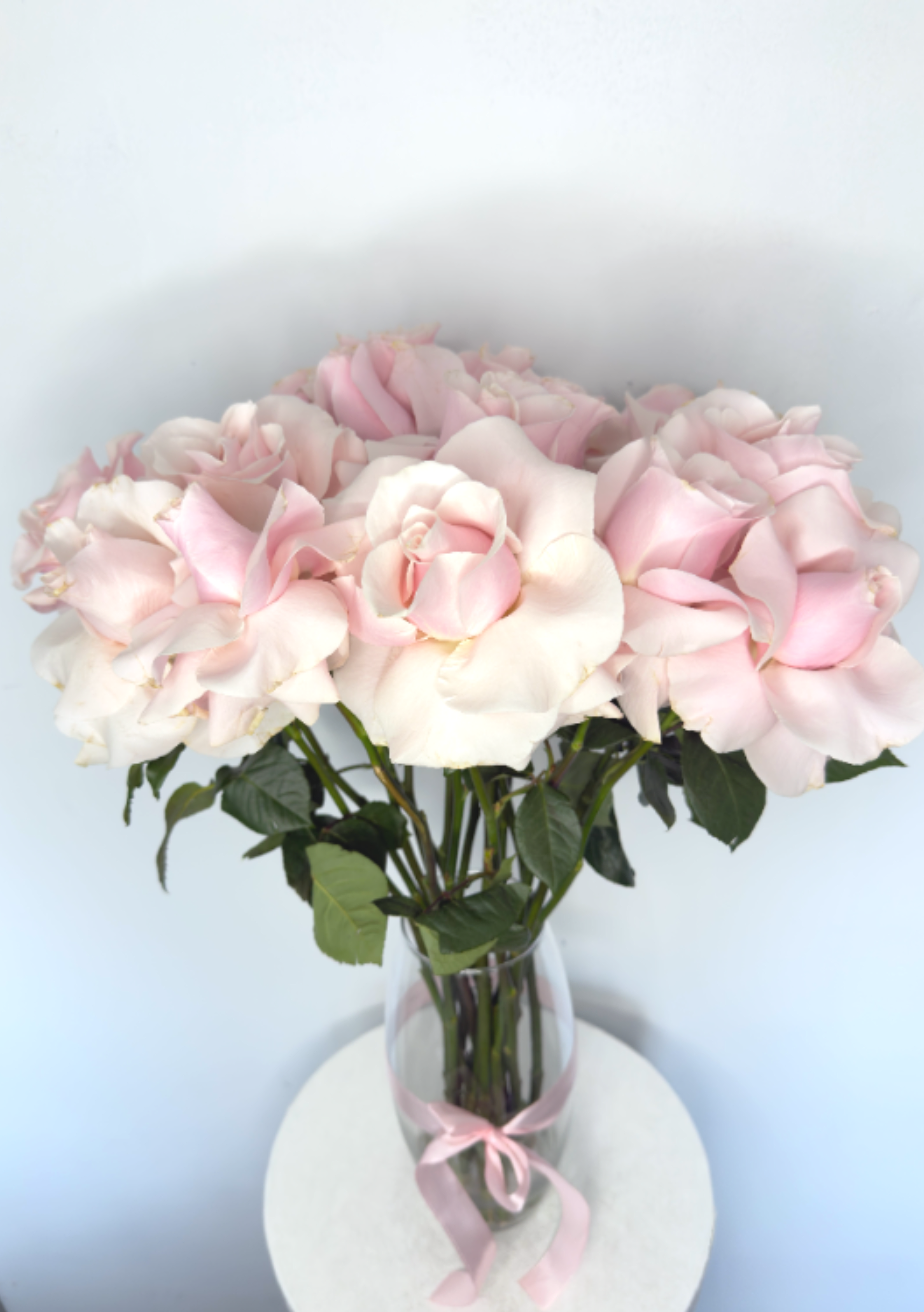 Cotton Candy Roses - Baby Pink Cotton Candy Roses is a soft and elegant arrangement of 20 hand-opened baby pink roses, designed to create a full, cloud-like look. Each rose is carefully opened by hand and arranged in a clear glass vase for a timeless and romantic finish.  Perfect for birthdays, anniversaries, baby showers, or to celebrate love with a delicate, luxury touch. This handcrafted rose arrangement brings warmth, beauty, and sweetness to any space.  ️ 20 fresh baby pink roses ️ Hand-opened for a fuller bloom ️ Glass vase included ️ Designed with care and attention to detail 
