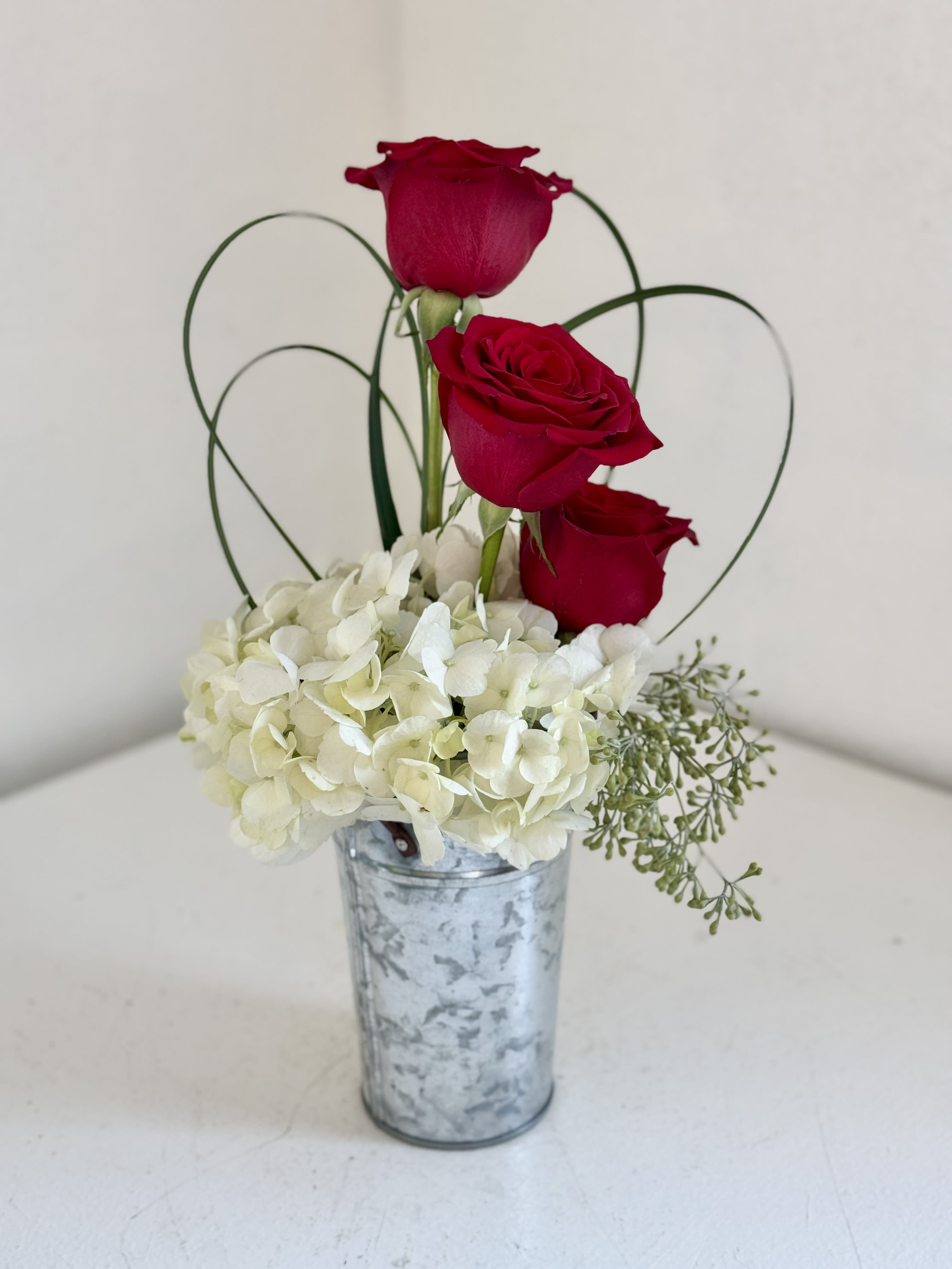 Cupid's Charm - Three mesmerizing roses with modern flair in a limited edition container. **Container May Vary**