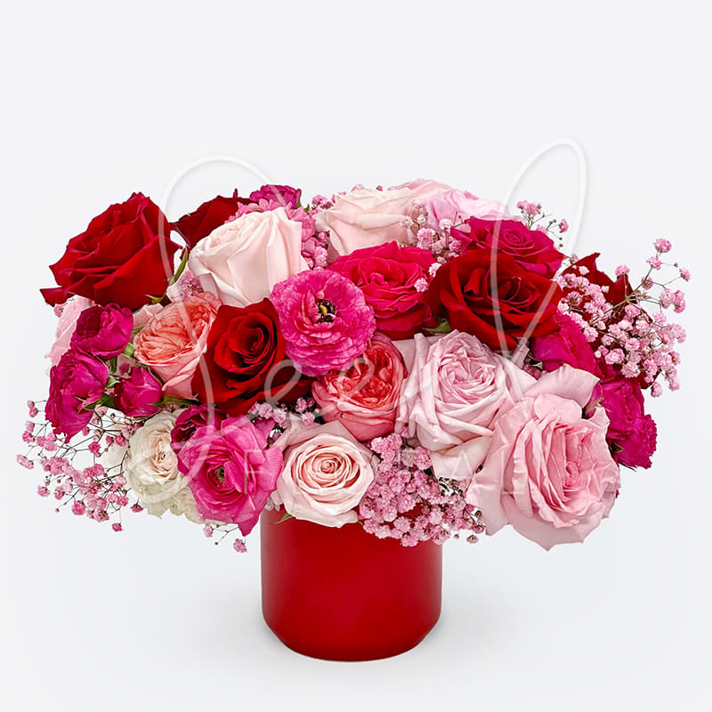 The Kendall - The All the Feels Arrangement is bursting with romance and color. Featuring a lush mix of red, blush, and pink roses paired with soft seasonal accents, this floral arrangement is designed in a bold red vase for a modern Valentine’s Day look.  Perfect for Valentine’s Day, anniversaries, birthdays, or just-because moments, this rose arrangement is full, joyful, and undeniably romantic. Whether you’re celebrating love or simply sending a sweet surprise, All the Feels delivers heartfelt beauty any day of the year.