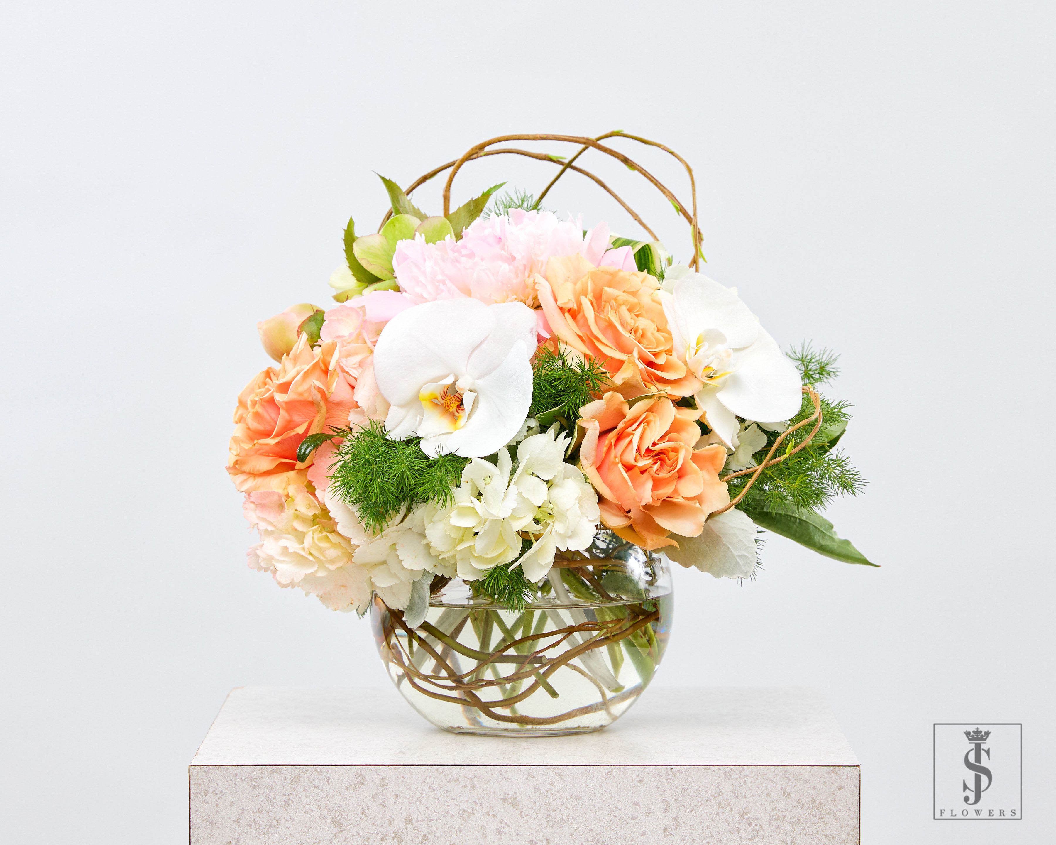 Peony Rose Glow - Bring a touch of luxury floral elegance to your space with our Peach Bliss Harmony Bouquet, a stunning round glass vase arrangement that blends fresh roses, orchids, hydrangeas, and peonies into one breathtaking display. Handcrafted by expert florists, this arrangement features soft peach roses, delicate white orchids, and creamy hydrangeas, accented with lush greenery and artistic curly willow branches for a modern, organic touch. Perfect for weddings, anniversaries, birthdays, and home décor, this floral masterpiece radiates warmth and sophistication. Its romantic pastel tones make it an ideal centerpiece for any setting.   luxury flower arrangement, peach rose bouquet, orchid floral vase, fresh hydrangea centerpiece, pastel wedding flowers, Dallas luxury florist, premium flower delivery, elegant floral gift.
