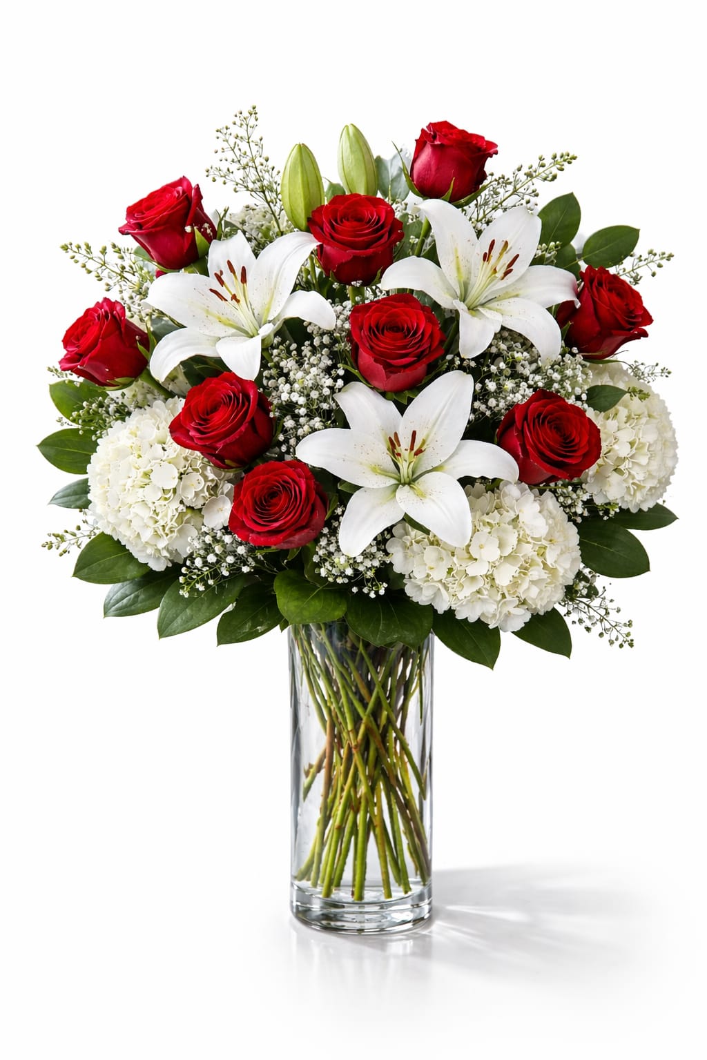 Pure Devotion Bouquet - Dozen Red Roses with White Hydrangea &amp; Lilies  Twelve classic red roses are beautifully arranged with lush white hydrangea and elegant white Asiatic lilies in a clear glass vase. This romantic Valentine’s Day flower arrangement combines timeless red roses with soft white blooms for a striking and elegant presentation.  Perfect for Valentine’s Day flower delivery, anniversaries, or expressing love and admiration, this dozen red rose arrangement makes a meaningful and unforgettable gift.