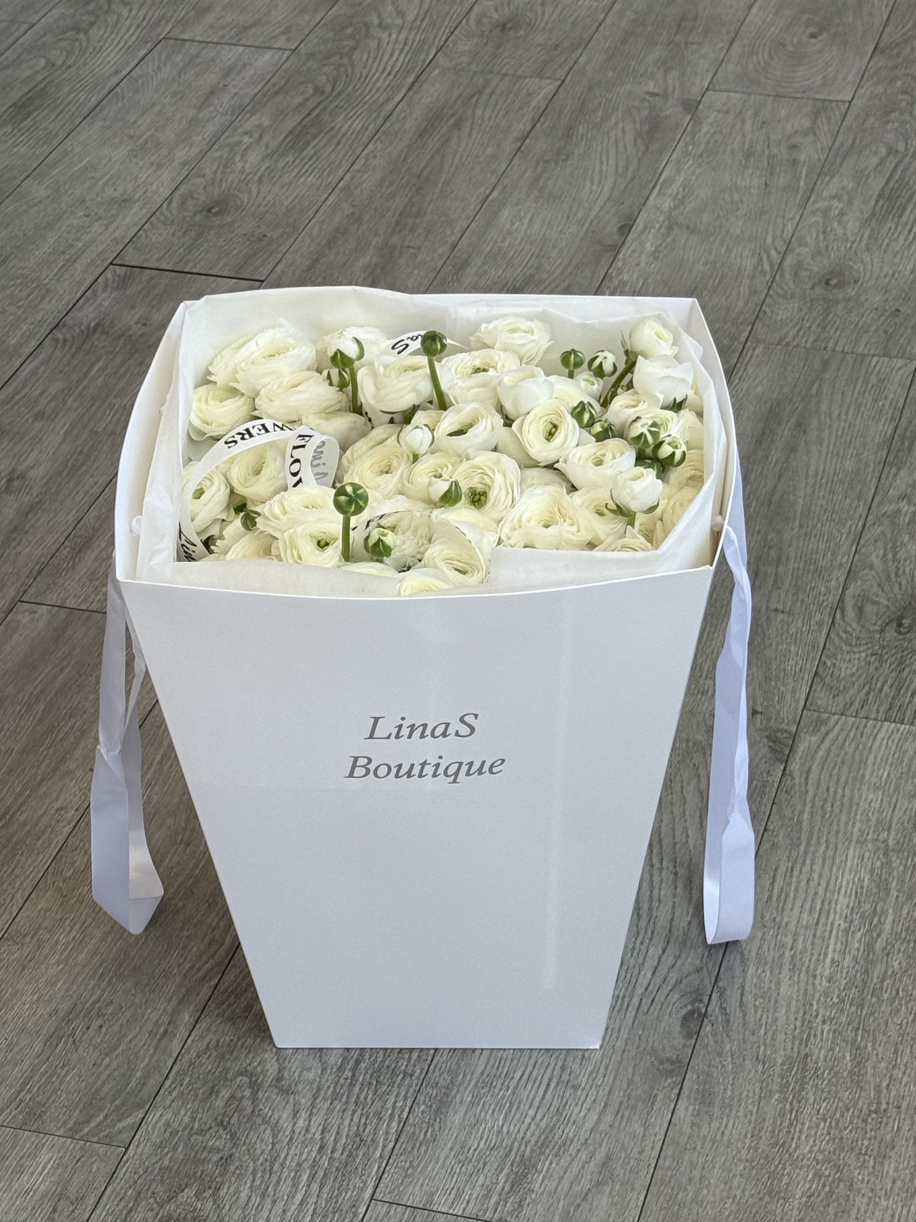 Ranunculus  - White ranunculus flowers symbolize purity, charm, and elegance. Their delicate, layered petals create a soft, romantic look, making them a popular choice for weddings and floral arrangements.