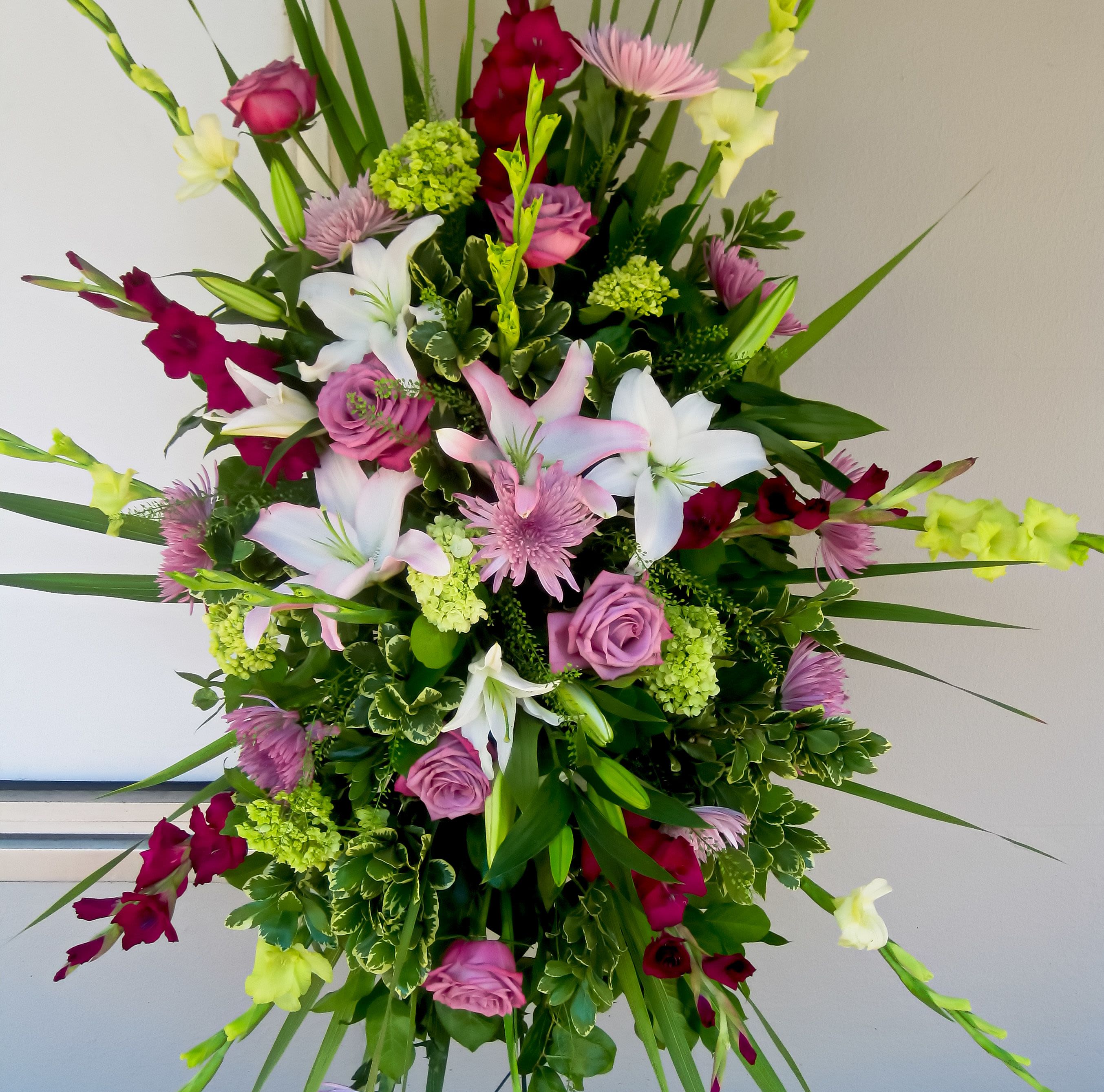 Pink Sympathy Easel ( Substitute any color) - Sympathy Sprays  come in all different sizes, shapes and colors. Please call any time to discuss your particular requests. As shown: with Lilies, Roses, Gladiolas , Spider Mums and Hydrangea