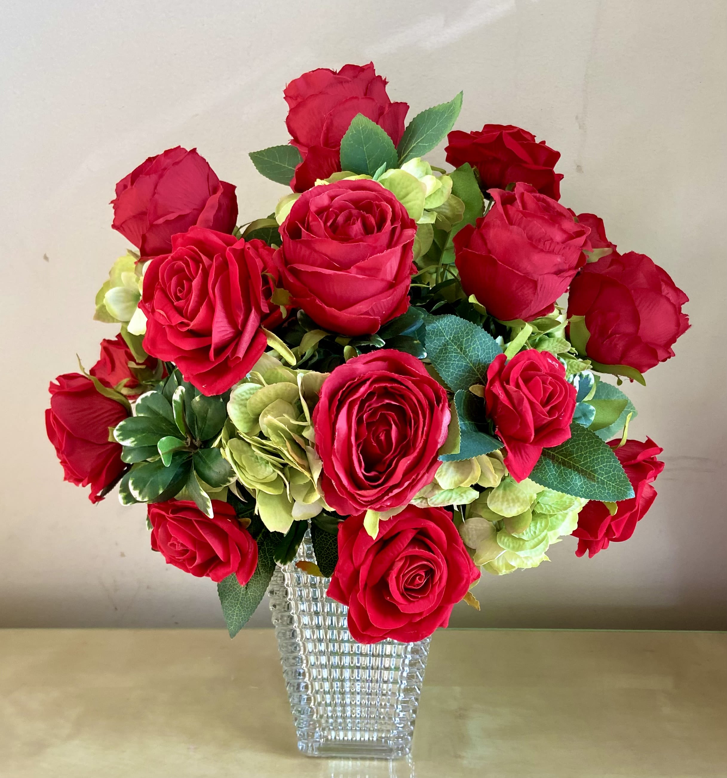 Forever Yours - Amazing silk arrangement with 18 red roses in a bed of green hydrangea. Great Valentine’s, Anniversary or Love You gift that brings endless joy.