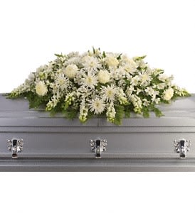  Enduring Light Casket Spray  - The purity of this all-white casket spray creates an aura of serenity and peace - a beautifully memorable final farewell to a lost loved one.  The elegant arrangement includes white alstroemeria, white snapdragons, white chrysanthemums, white spider chrysanthemums and million star gypsophila, accented with assorted greenery.  Approximately 54" W x 23" H  Orientation: N/A