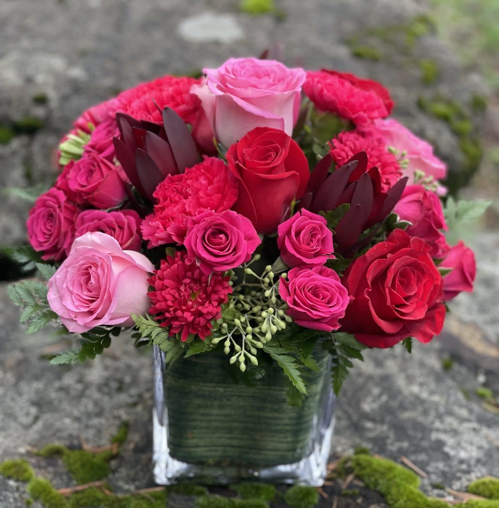 Rosy Day  - Modern compact cube with spray and standard roses,  carnations and a touch of burgundy.  Rosy and beautiful