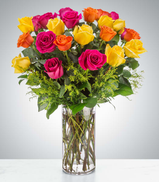 The Sound of Joy - Send an explosion of color with this long-stemmed rose arrangement perfect for celebrations or showing your appreciation. A great alternative to the classic red rose, send a giant arrangement of multicolored bright roses. (2 dozen roses)  Approximate Dimensions: 20''D x 28""H