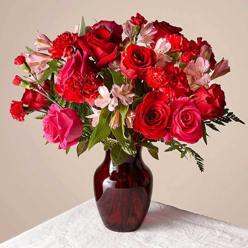The Valentine Bouquet - Hot pink roses, carnations &amp; more flowers make a bold statement of your love for Valentine's Day with the Valentine Bouquet. Approximately 16" H x 16" W.