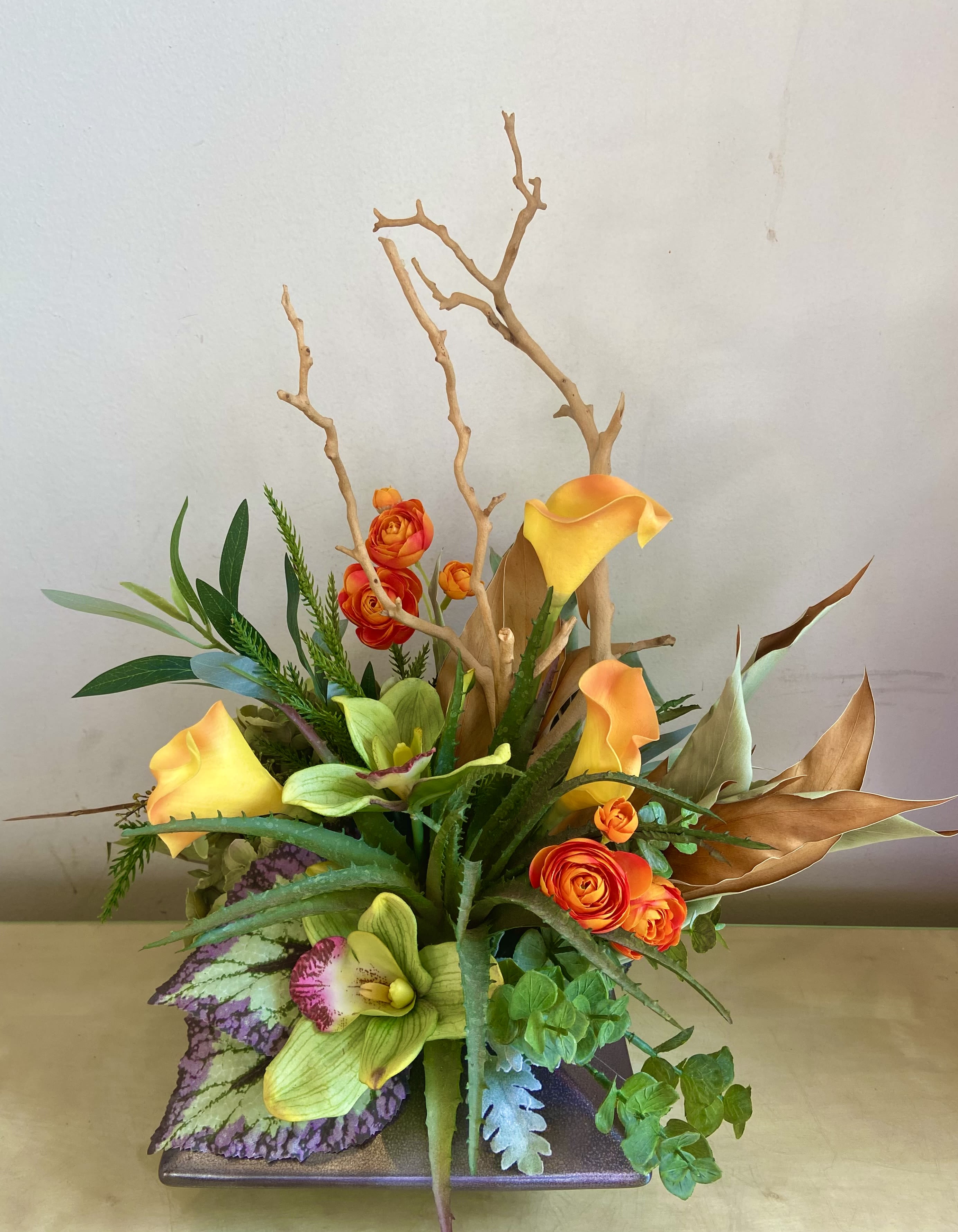 The Winner! - So cool, so trendy!  Silk, dried and organic floral arrangement in low cerramic vase. Natural manzanita branch with succulent, callas, ranunculus, hydrangea, cymbidium orchid blossoms and more. 