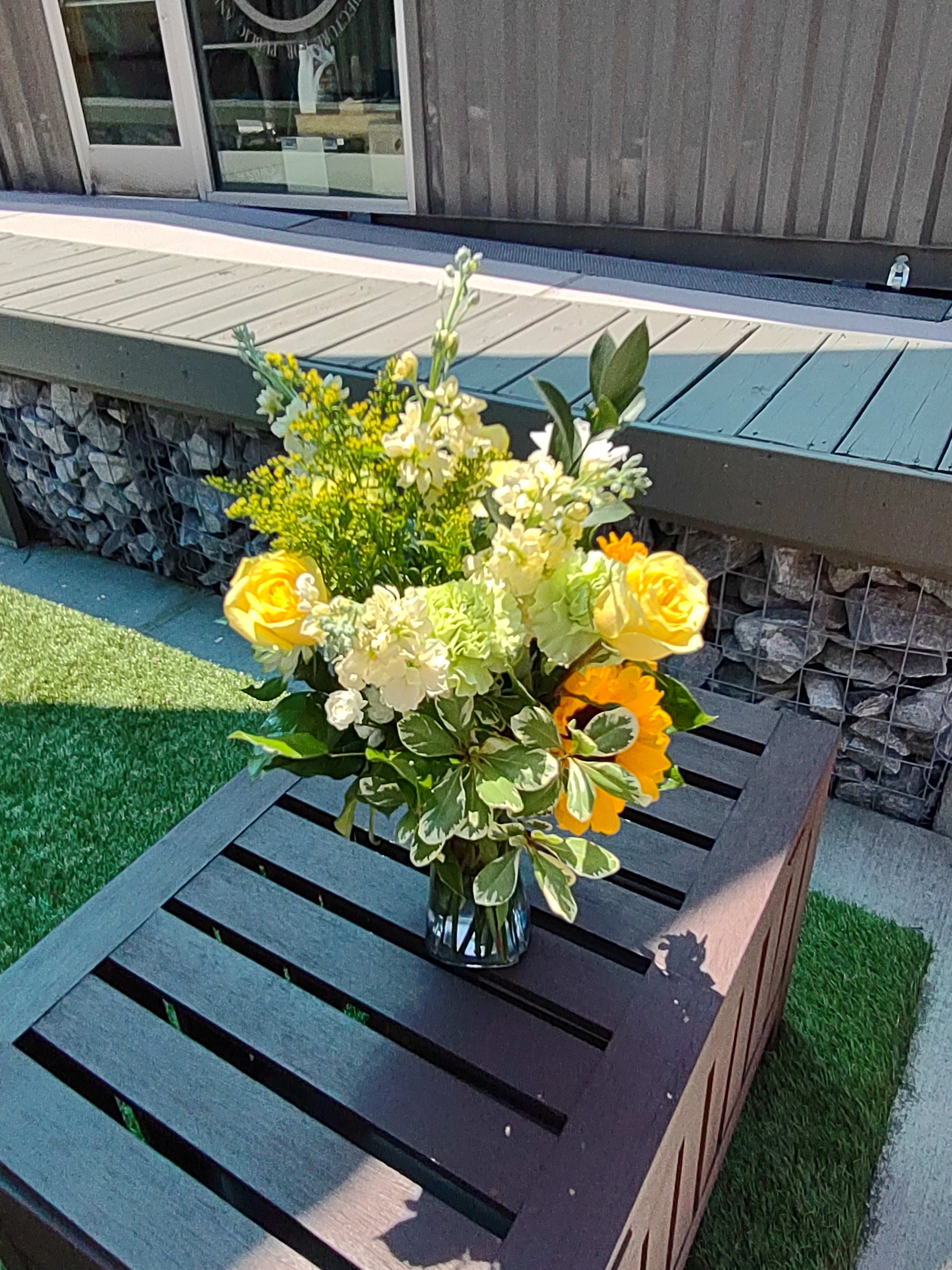 South Fulton Sunflower - A summery blend of white stock, Sunflowers, Roses and Carnations with assorted filler and greenery. 