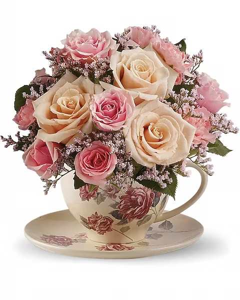 Teleflora's Victorian Teacup Bouquet - Send warm wishes with this lovely gift bouquet that arrives in a ceramic teacup. This charming, old-fashioned bouquet features pink and crème roses. Cream roses, pink spray roses, miniature pink carnations and delicate pink limonium are presented in a teacup and saucer with a Victorian flower pattern.  Orientation : All-Around All prices in USD ($) Due to an increase in the cost of roses, some product prices may be impacted during the Valentine’s delivery period.
