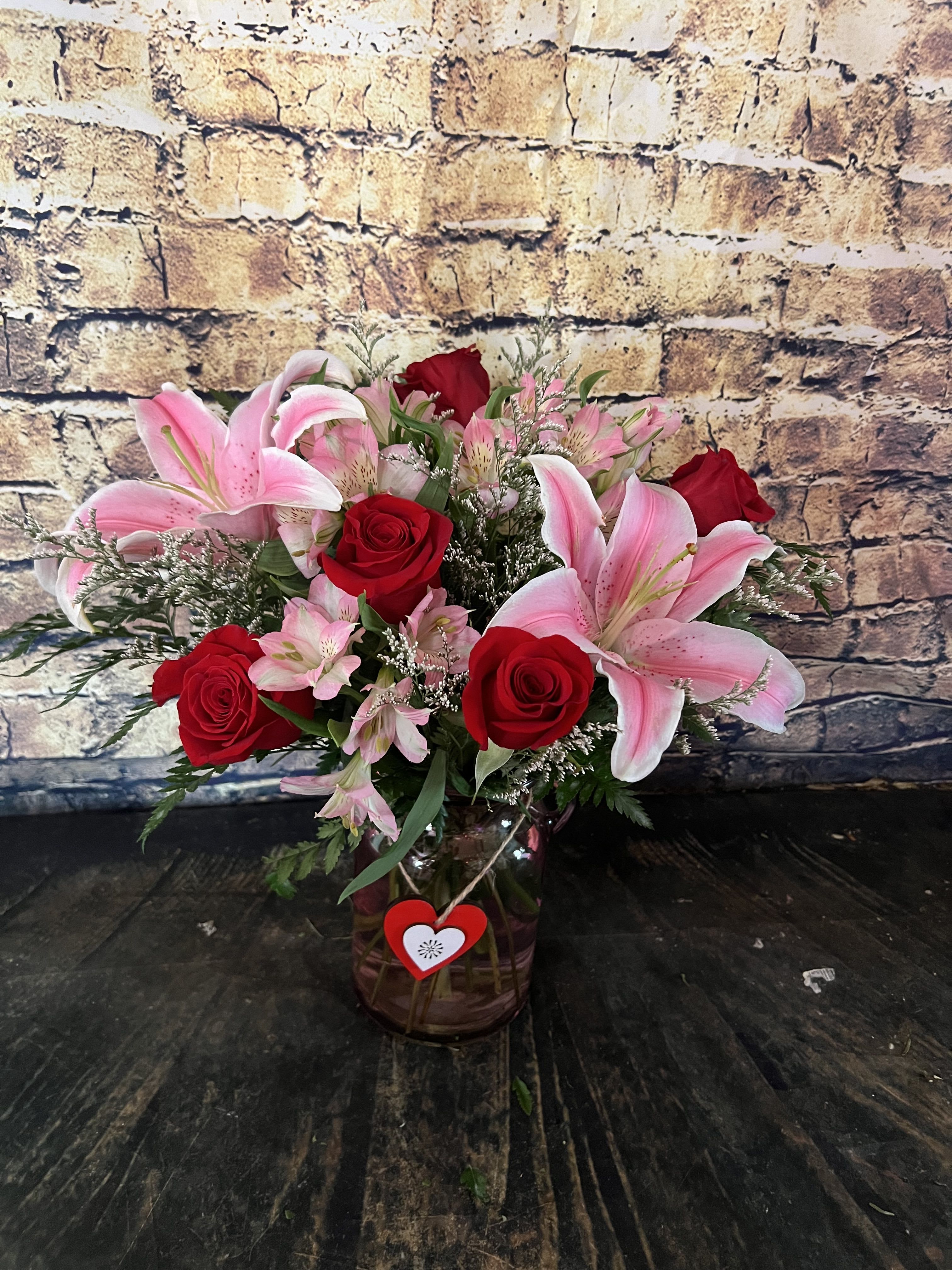 Stargazing Into My Heart  - Truly a classic with Red Roses and Stargazer Lilies accented with Peruvian Lilies is so sweet!  This Pink Vase with Heart Charm is a wonderful keepsake for future floral gifts for throughout the year!