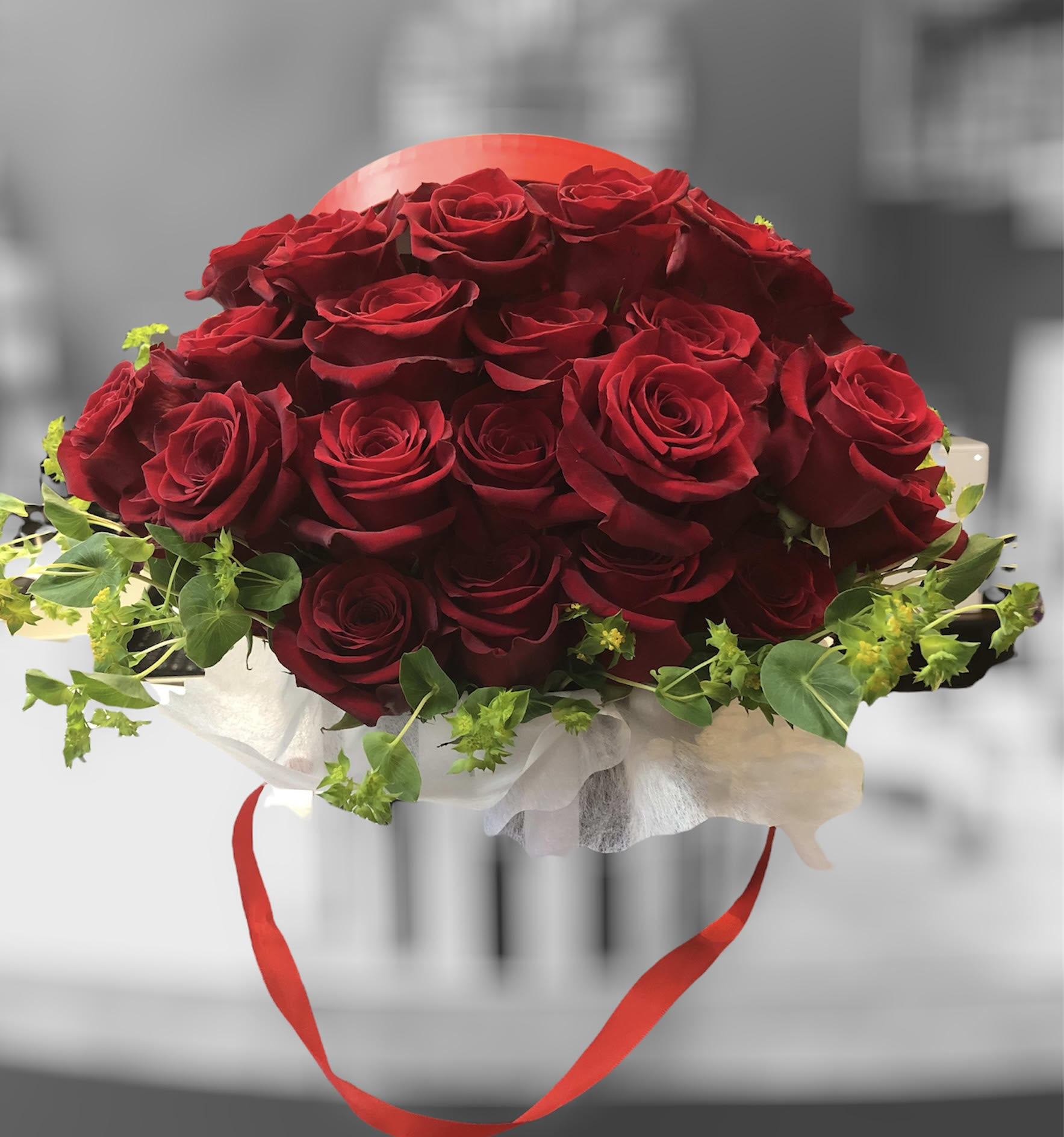 Red roses in a hat box - Show your Love with a Modern Classic - Red color is a quintessential symbol of enduring passion. 30 Extra fancy luxurious premium RED ROSES capture the essence of romance. Accented with seasonal flowers and foliage in a modern hat box.  *** Foliage, accent flowers and black or red hat box may vary subject to availability.