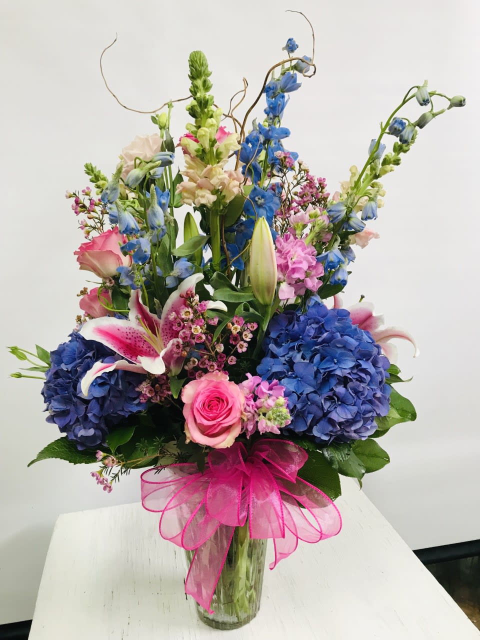 Birthday #21 - Arrangement of fresh cut flowers designed in a glass vase. Colors can be modified depending on availability.