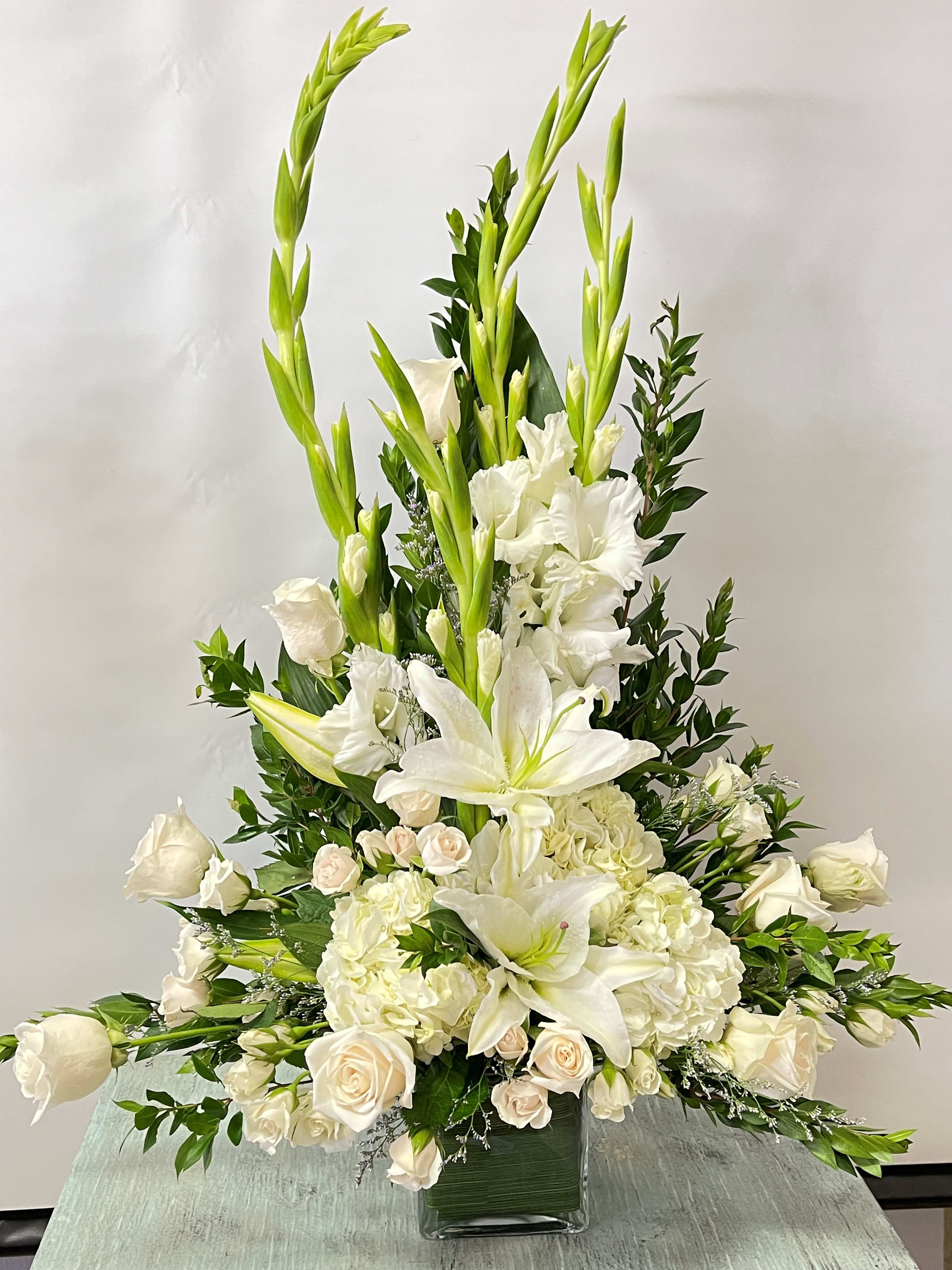 Sympathy Glass Cube #17 - All white arrangement of fresh cut flowers designed in a clear glass cube. Color can be modified depending on availability.
