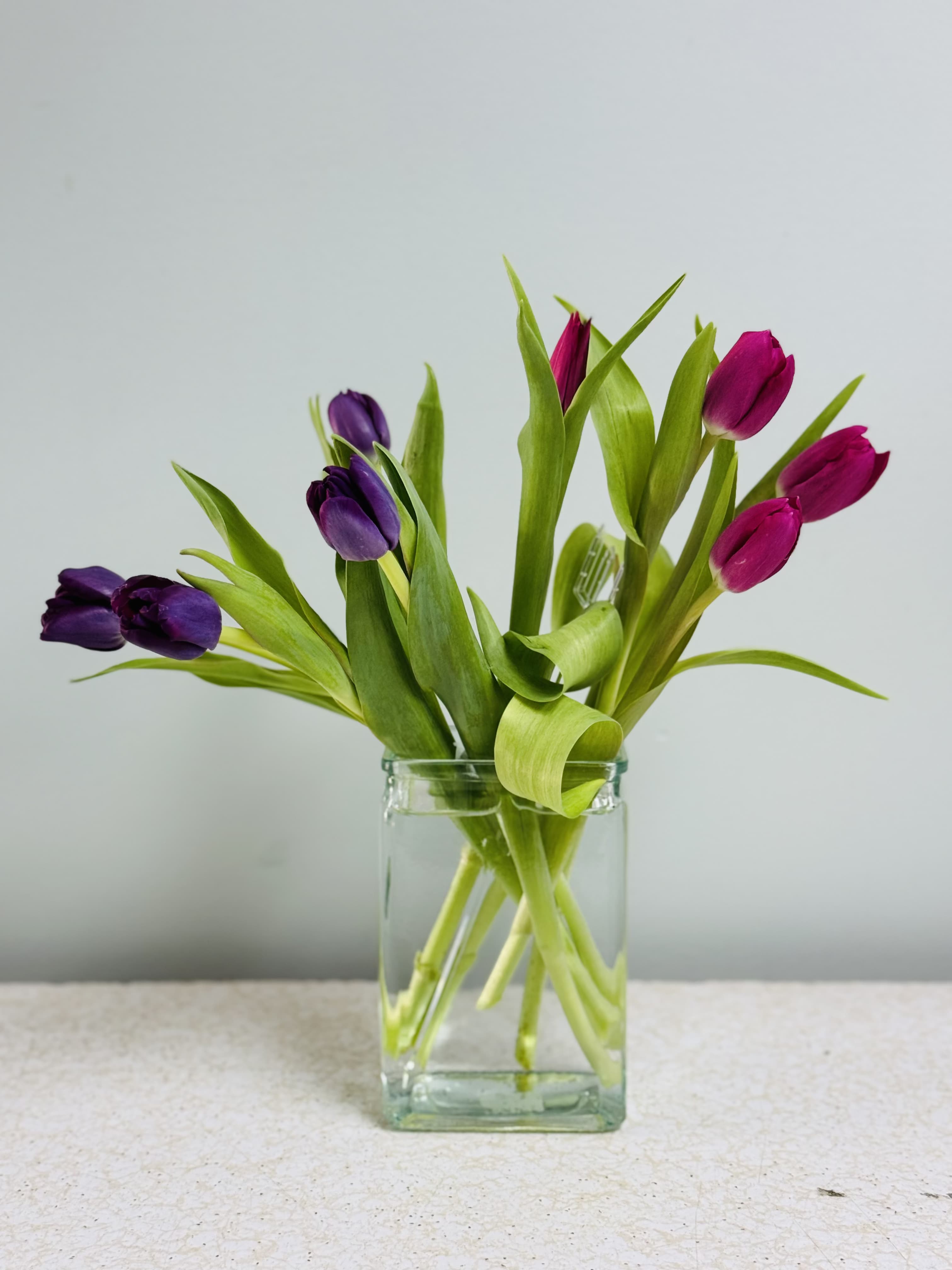 Two Lips Bouquet  - Modern and simple, this arrangement consists of eight tulips in two colors with no greens, in a clear glass vase. Classy and modern.