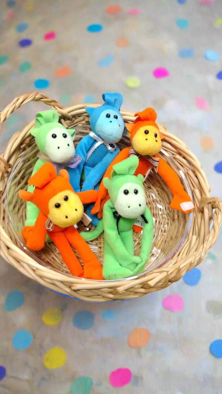 Monkey Mates: Whimsical Wraps - Introducing our delightful plush Monkey Mates: Whimsical Wraps, a charming addition to any home or gift collection! Standing at approximately 8" tall, these vibrant companions are designed to spread joy and whimsy to both children and adults alike. Each monkey features playful Velcro hands that allow them to easily wrap around a bud vase, transforming ordinary decor into a fun and eye-catching display. With their colorful designs and friendly expressions, these plush monkeys are not only perfect for gifting on special occasions but also make a delightful treat for yourself. Brighten up your space and let the playful spirit of our Whimsical Wraps monkeys bring a smile to your day!