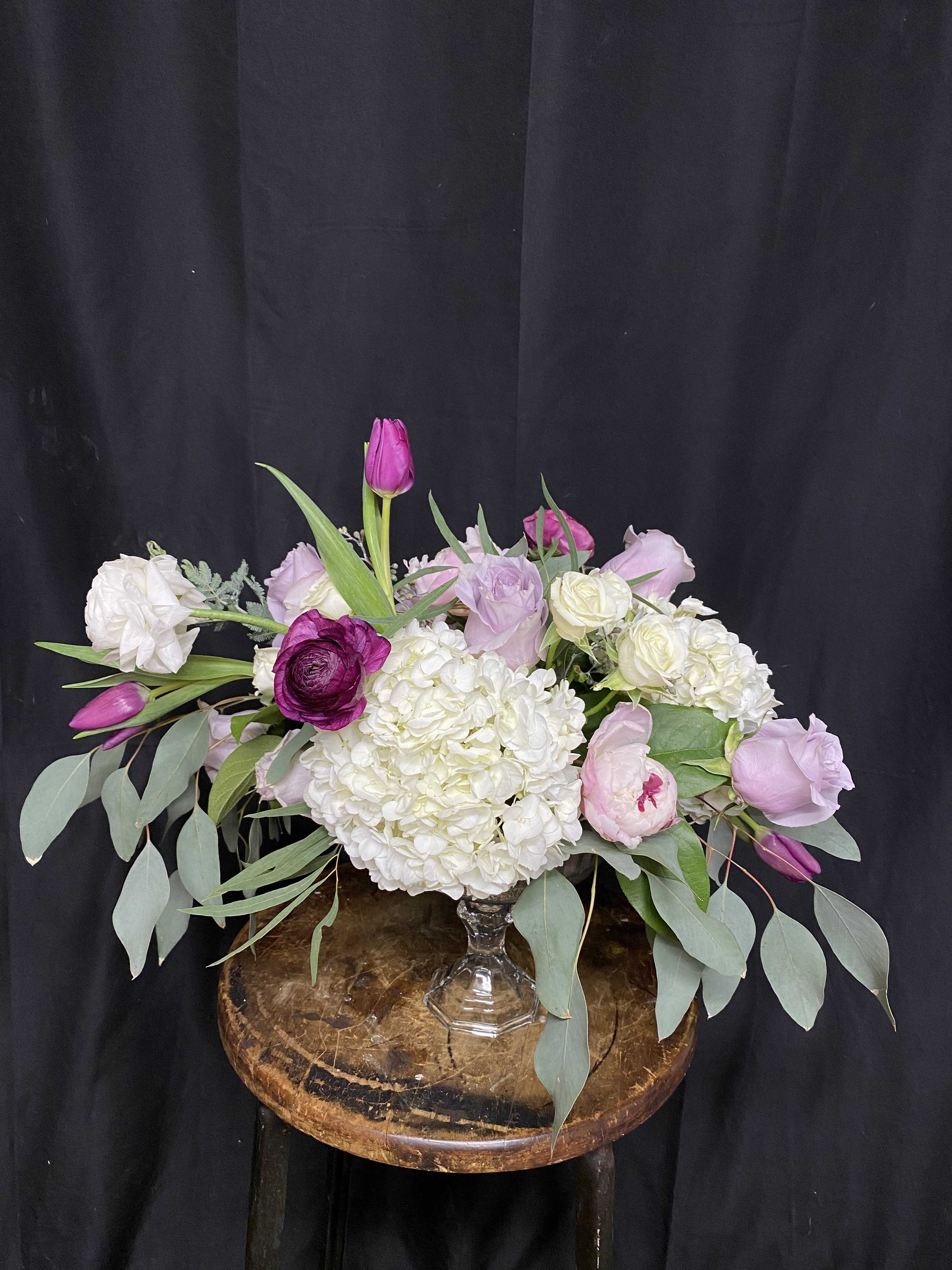 Design of the day Glass compote bowl  - The designer will select only the best flowers of the day to create arrangement or bouquet inspired by the seasonal beauty of the flowers.  PLEASE NOTE: The flower selection in the picture is for the design sample and to represent the sizes. The selection of the the flower and color schemes will vary due to seasonal availability.  Please order 48 hours in advance.  