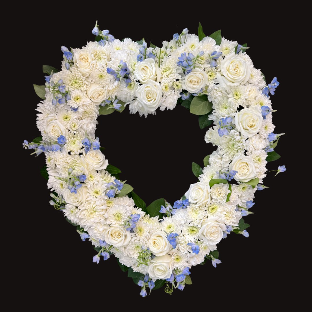 Blue Open Heart CHH5800 - Let their special memories live on forever while expressing your deepest sympathy. This striking, heart-shaped tribute is crafted by our expert florists from fresh, beautiful blue and white blooms to help you offer your comfort and support during a difficult time. Heart-shaped arrangement of fresh blue and white flowers such as roses, delphinium, carnations and more Comes on a wire easel with accents and satin ribbon. 