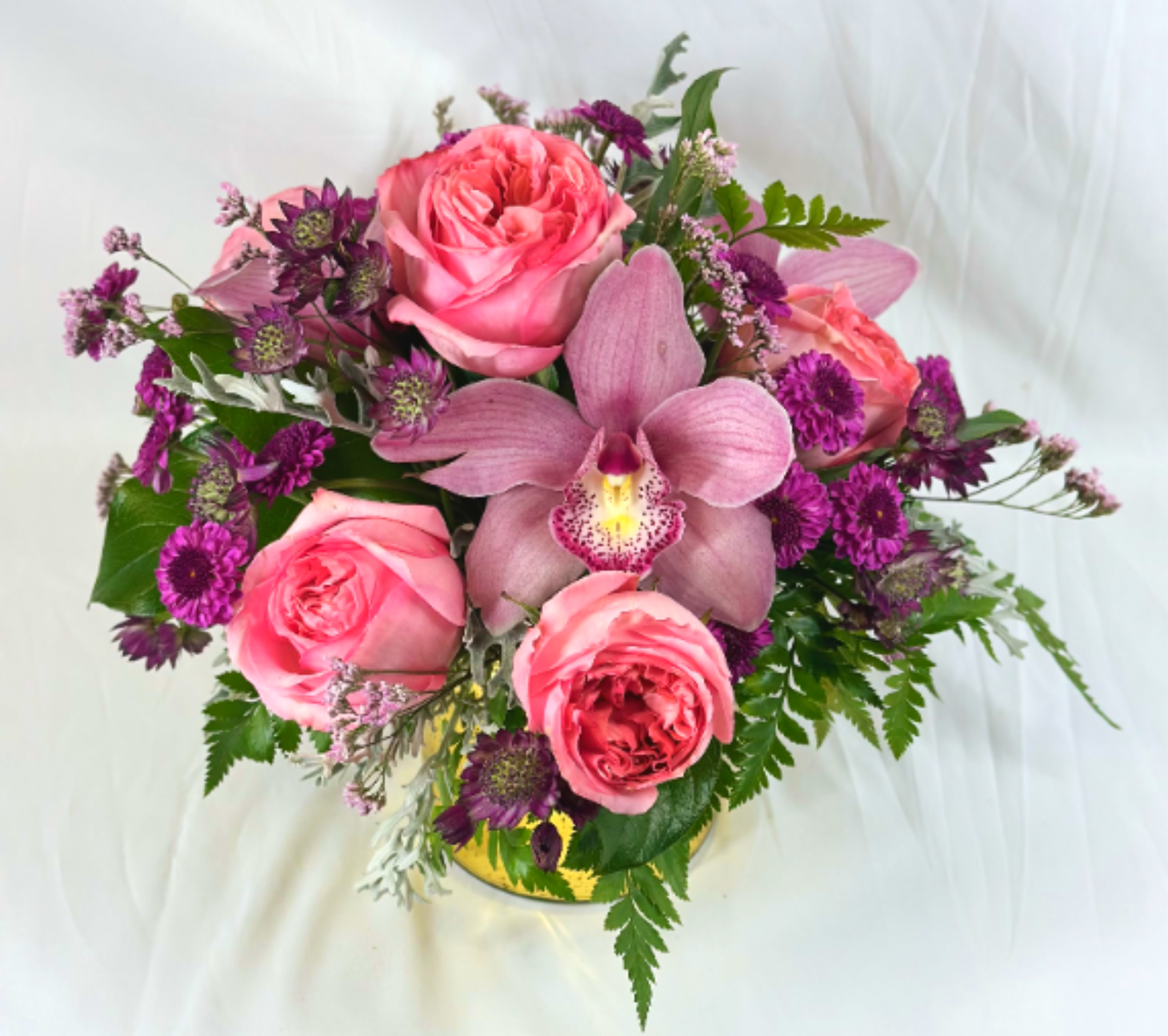 Luxurious Love with Orchids and Roses - Go all out with this upscale arrangement showcasing elegant orchid blossoms and beautiful roses in a shimmering gold vase. This is truly a rich floral fantasy.  If the featured flowers are not available we will design your arrangement using the freshest blooms of equal or greater value