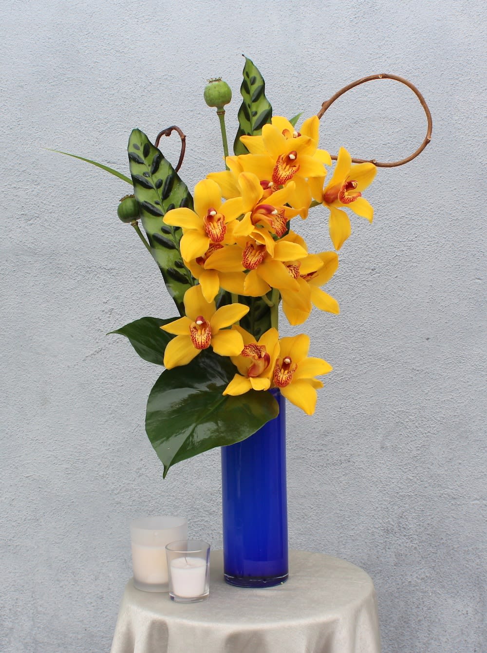 Cymbidium Orchids - Gorgeous Cymbidium Orchids in a blue vase. (vase may vary depending on availability)  