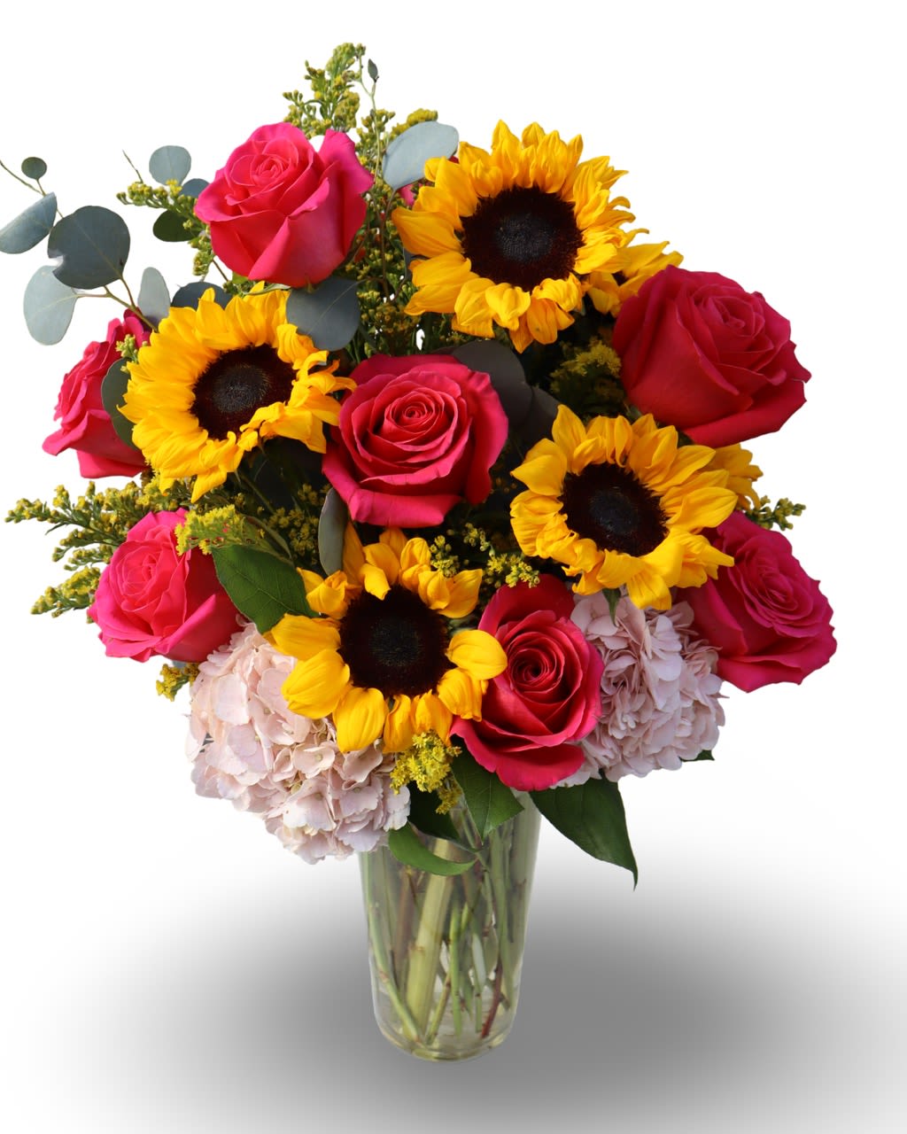Sunlit Celebration  - This vibrant arrangement blends golden sunflowers with lush hot pink roses and soft hydrangea, finished with textured greenery for depth and movement. Designed in a clear vase, it offers a fresh, high-end look that feels joyful without losing sophistication. A beautiful way to celebrate life’s special moments. 24”H. 20”W. 