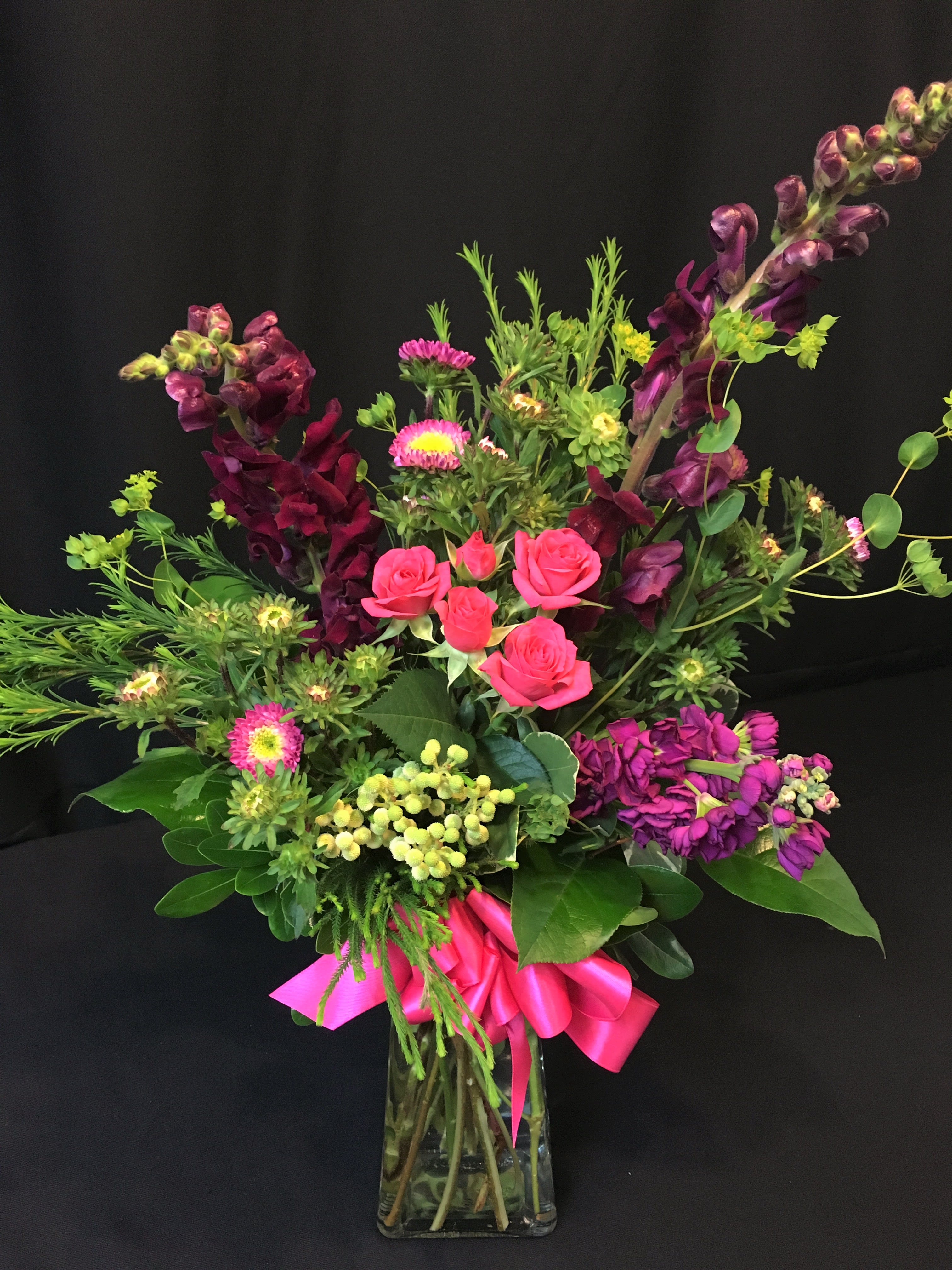 Valentine Medium Premium Mix - Designer's choice of flowers and colors.  This modern rectangular glass vase design contains premium flowers, greenery and seasonal mixed flowers. Small size bouquet.  SUPPORT AMERICAN MANUFACTURERS - We now carry American made vases and you can request one with your rose order