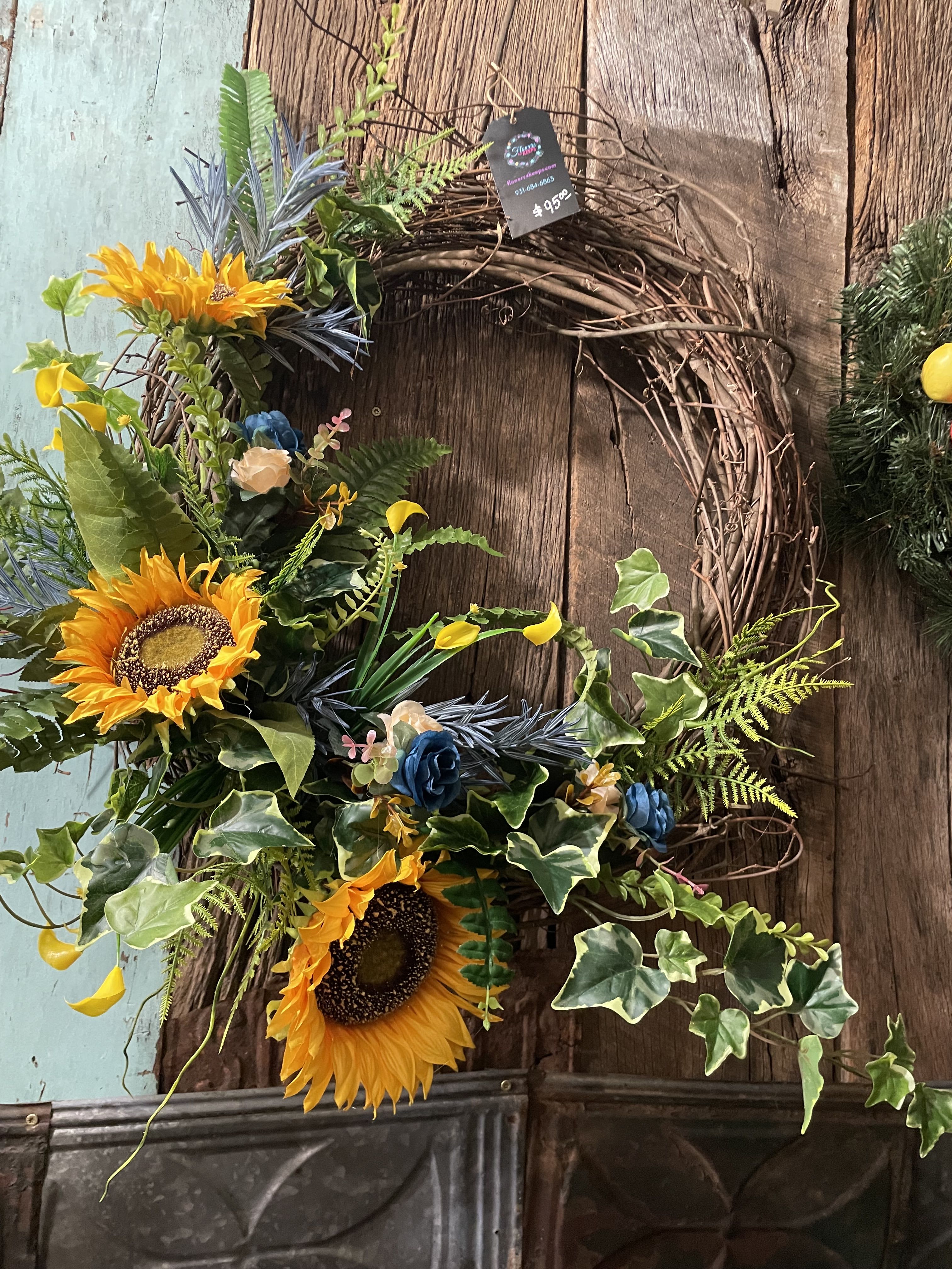 Callas &amp; Sunflowers Silk Grapevine Wreath  - A grapevine wreath covered in various shades of yellow, blue silk flowers,  mixed greens and callas , sunflowers and leaves. 
