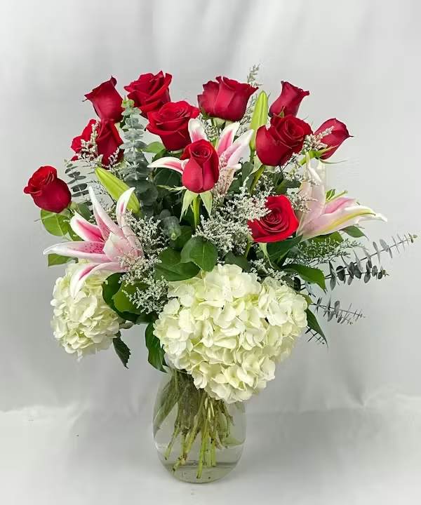 Wild for You - 12 long stem Eucadorian grown  red roses are surrounded by fluffy pillows of white hydrangea. Scented lilies are placed between the roses along with spa eucalyptus. This stunner is something to be wild over.