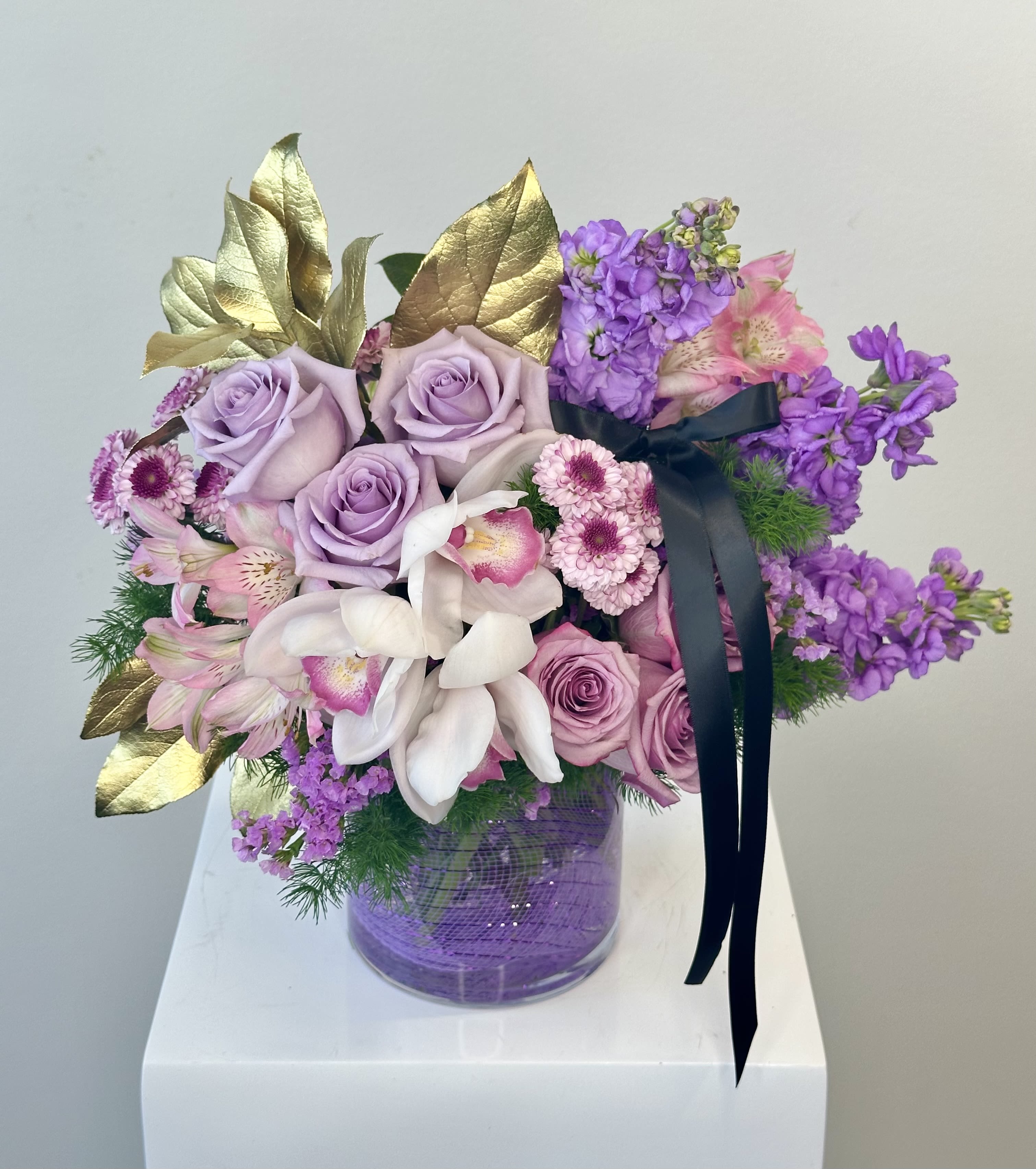 FurryTail Endings Bouquet - Compassion in Full Bloom!  More than a beautiful floral arrangement, the FurryTail Endings Bouquet is a heartfelt tribute to second chances. A portion of each purchase supports FurryTail Endings, a passionate nonprofit organization based in Orange County, California, dedicated to rescuing, rehabilitating, and rehoming abandoned and at-risk animals.  FurryTail Endings works tirelessly to ensure that every animal has the opportunity for a safe, loving home. Through community outreach, medical care, and adoption services, they give voice—and hope—to those who cannot speak for themselves.  With this bouquet, you’re not just sending flowers—you’re helping to rewrite a deserving animal’s story.  This charming arrangement features: 	•	Classic roses for love and devotion 	•	Graceful campanula symbolizing gratitude and support 	•	Fragrant stock for lasting beauty and affection 	•	Soft lisianthus for calm and resilience 	•	Whimsical bunny tails as a playful nod to the furry friends you’re helping  Each bloom is thoughtfully chosen to convey compassion, comfort, and joy.  Presented in a round vase lined with elegant black lace, this bouquet is both refined and heartwarming—perfect for any occasion that calls for love and purpose.  Send beauty. Share hope. Save lives. 