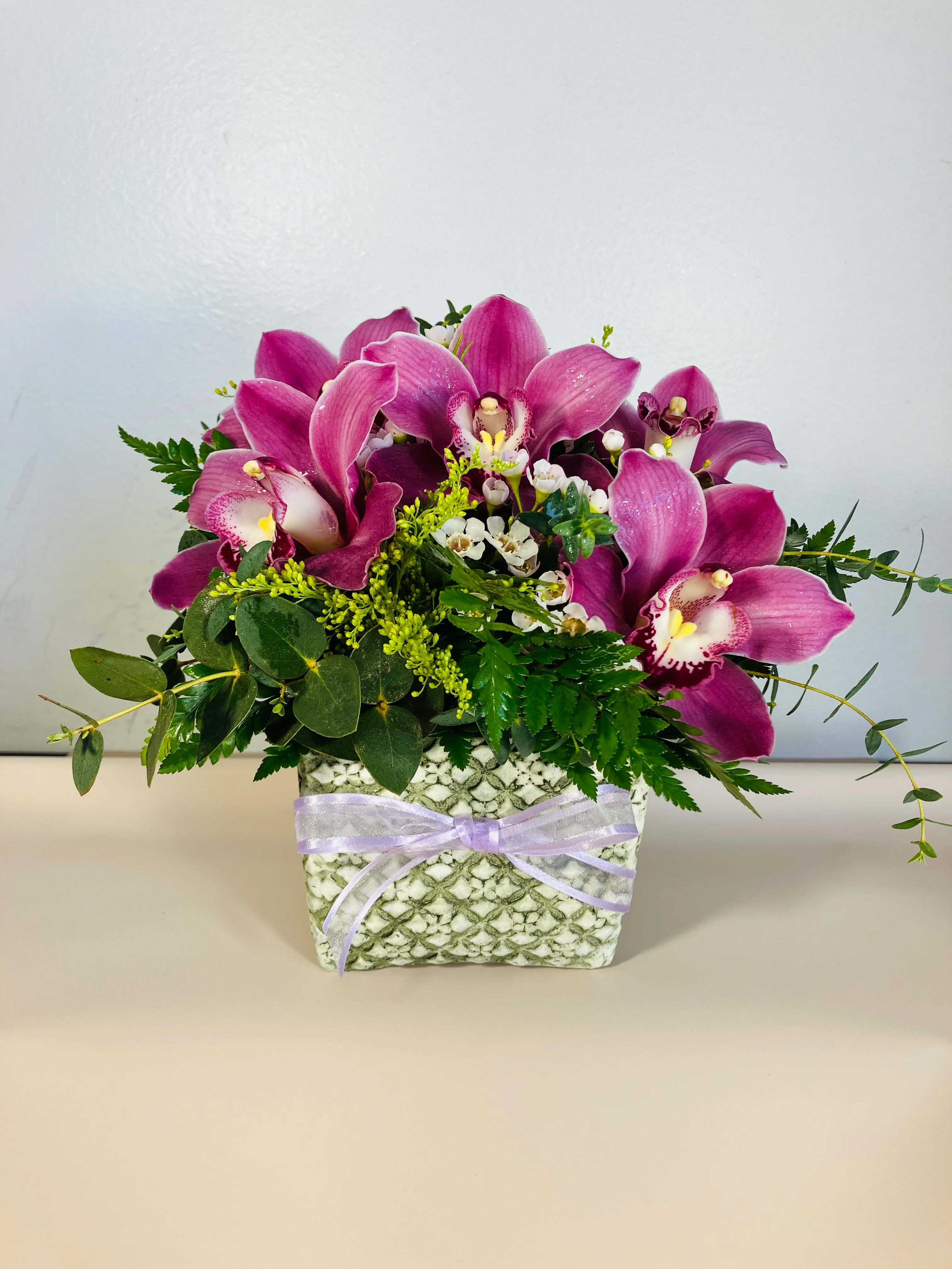 With Honor Pink - An elegant arrangement of pink cymbidium orchids. 