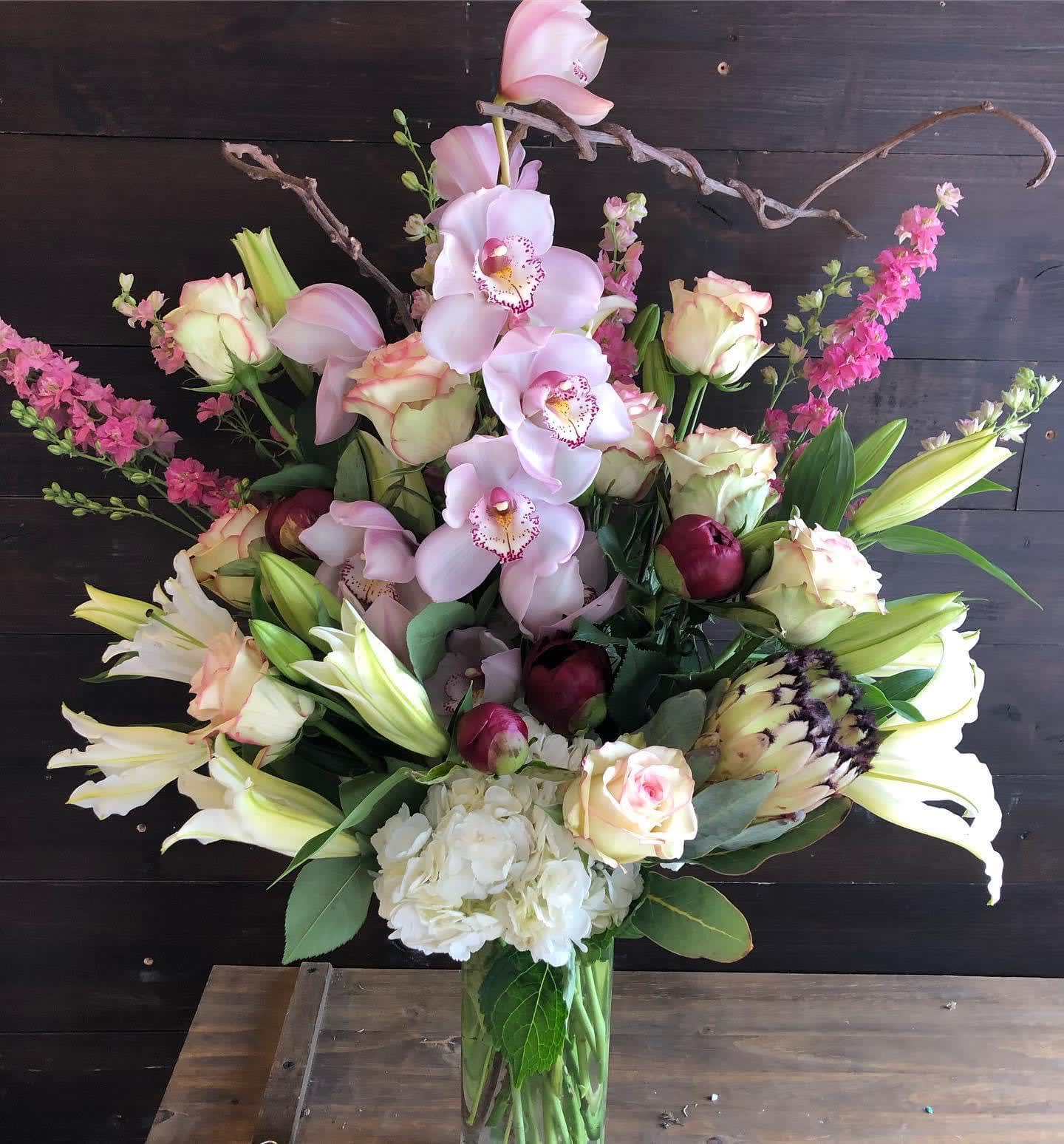 JUST BECAUSE GRAND! - This 32 inch tall design is sure to get her attention. It is filled with hydrangeas, pink roses, pink tulips, white lilies, Calla Picasso (simply the BEST calla variety) and orchids to name a few.  