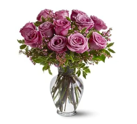 A Dozen Lavender Roses  - Adoration and enchantment, with a dash of regal majesty - the lavender rose says it all. With tone-on-tone accents, this luxurious dozen offers a striking, yet softly feminine, floral bouquet for any occasion. 12 lavender roses, with variegated pittosporum and salal, arrive in a classic glass urn vase.  Orientation: All-Around   All prices in USD ($) 