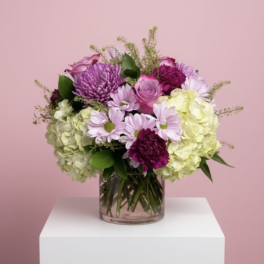 PURPLE PASSION - Soft lavender blooms arrangement featuring roses, hydrangea, cremones, carnations in a 5'' glass cylinder