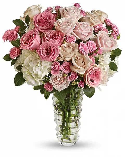 Blushing Elegance - Soft, romantic, and timeless, Blushing Elegance features a luxurious mix of premium pink and blush roses nestled among lush white hydrangea and fresh greenery. Designed in a clear glass vase, this full, garden-inspired arrangement is perfect for celebrating love, milestones, gratitude, or simply making someone feel truly special. Its delicate color palette and abundant blooms make it a beautiful statement piece for any occasion.  Vase may vary due to availability.