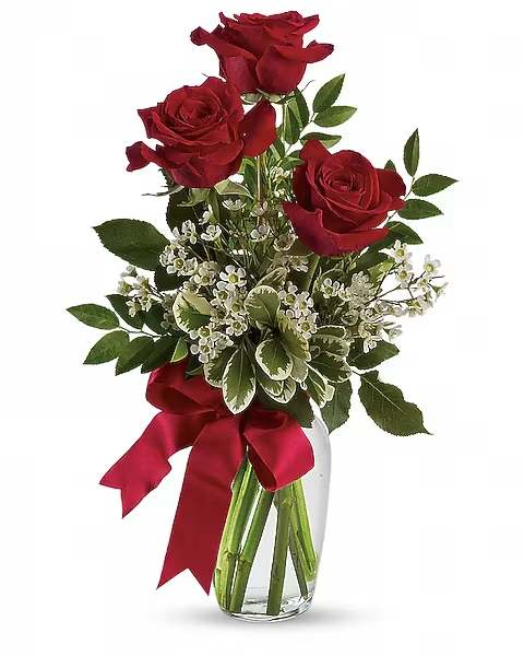 Thoughts of You Bouquet with Red Roses - It's the thought that counts, but it counts a bit more when it is expressed with three gorgeous red roses in a lovely arrangement tied up with a red satin ribbon. The flowers are bright and the price is right - the perfect combination for a sweet surprise.  This charming bouquet includes three red roses accented with white waxflower, huckleberry and pittosporum along with a red satin ribbon. Delivered in a clear glass vase.  Approximately 10 1/2" W x 16 1/2" H    Orientation : All-Around  All prices in USD ($)  Due to an increase in the cost of roses, some product prices may be impacted during the Valentine’s delivery period.